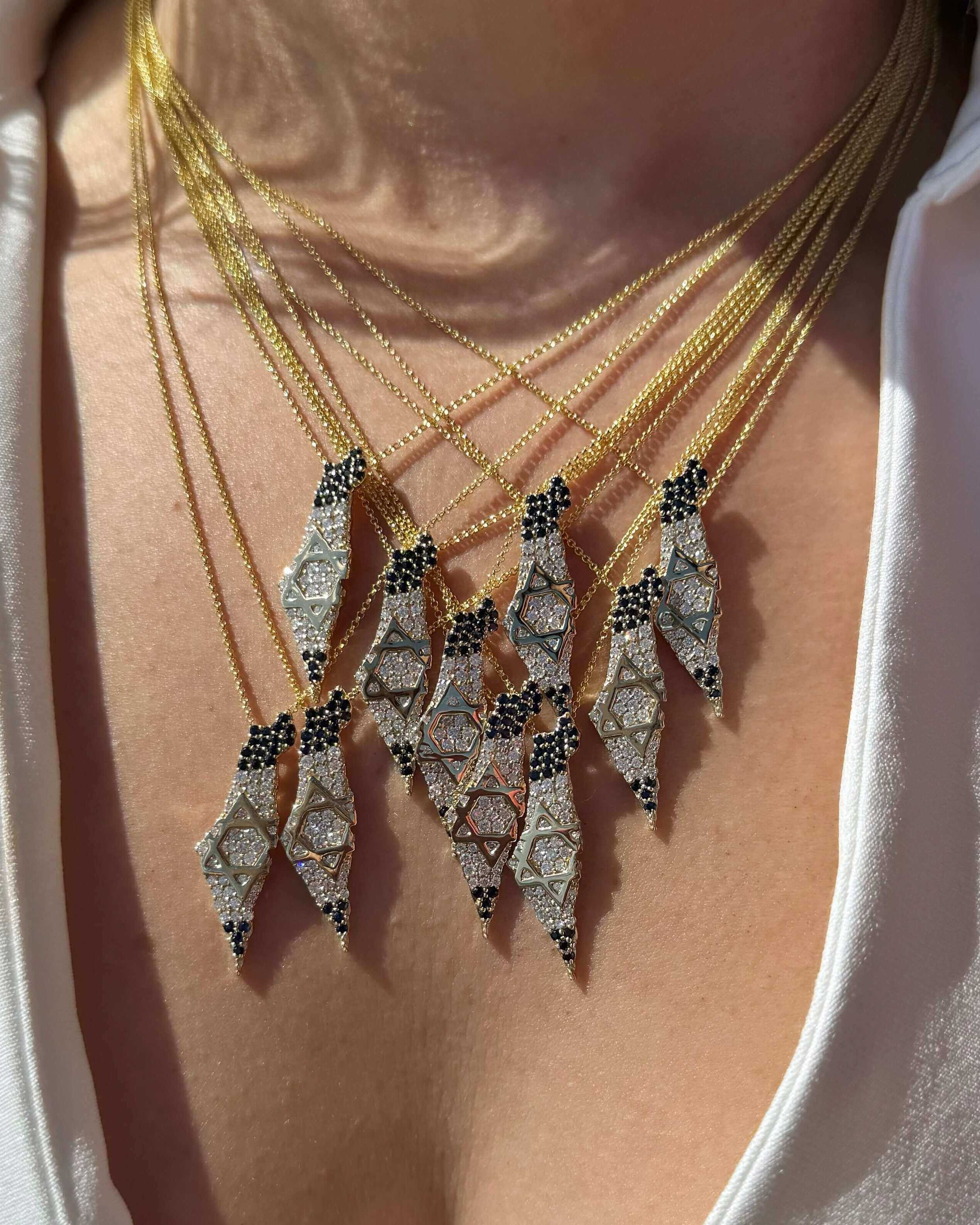 Stunning layered necklaces featuring unique Star of David pendants on gold chains, perfect for any occasion.