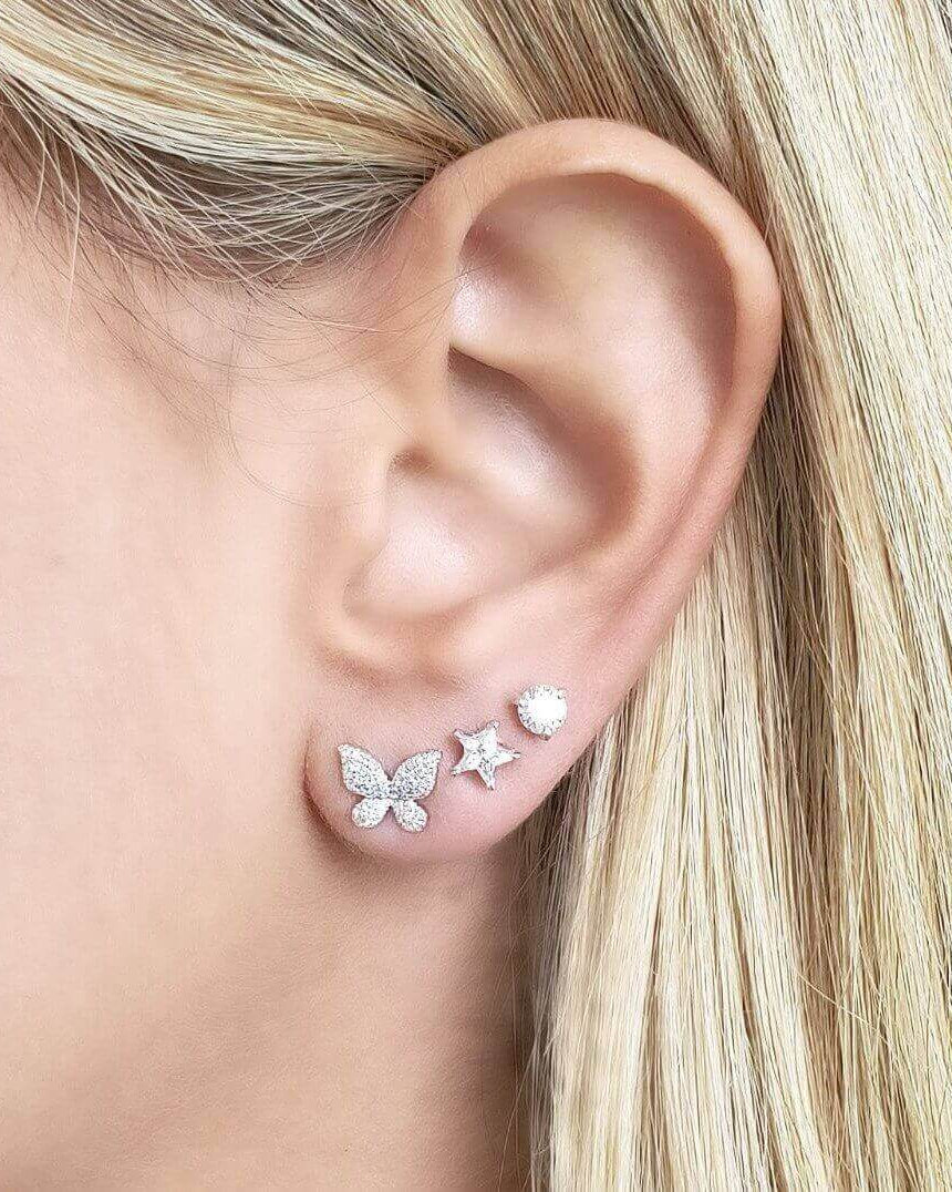 Elegant diamond stud earrings featuring butterfly and star designs, enhancing any outfit with sparkle.