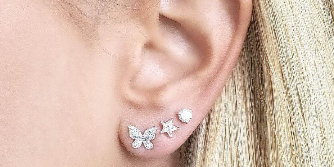 Elegant diamond stud earrings featuring butterfly and star designs, enhancing any outfit with sparkle.