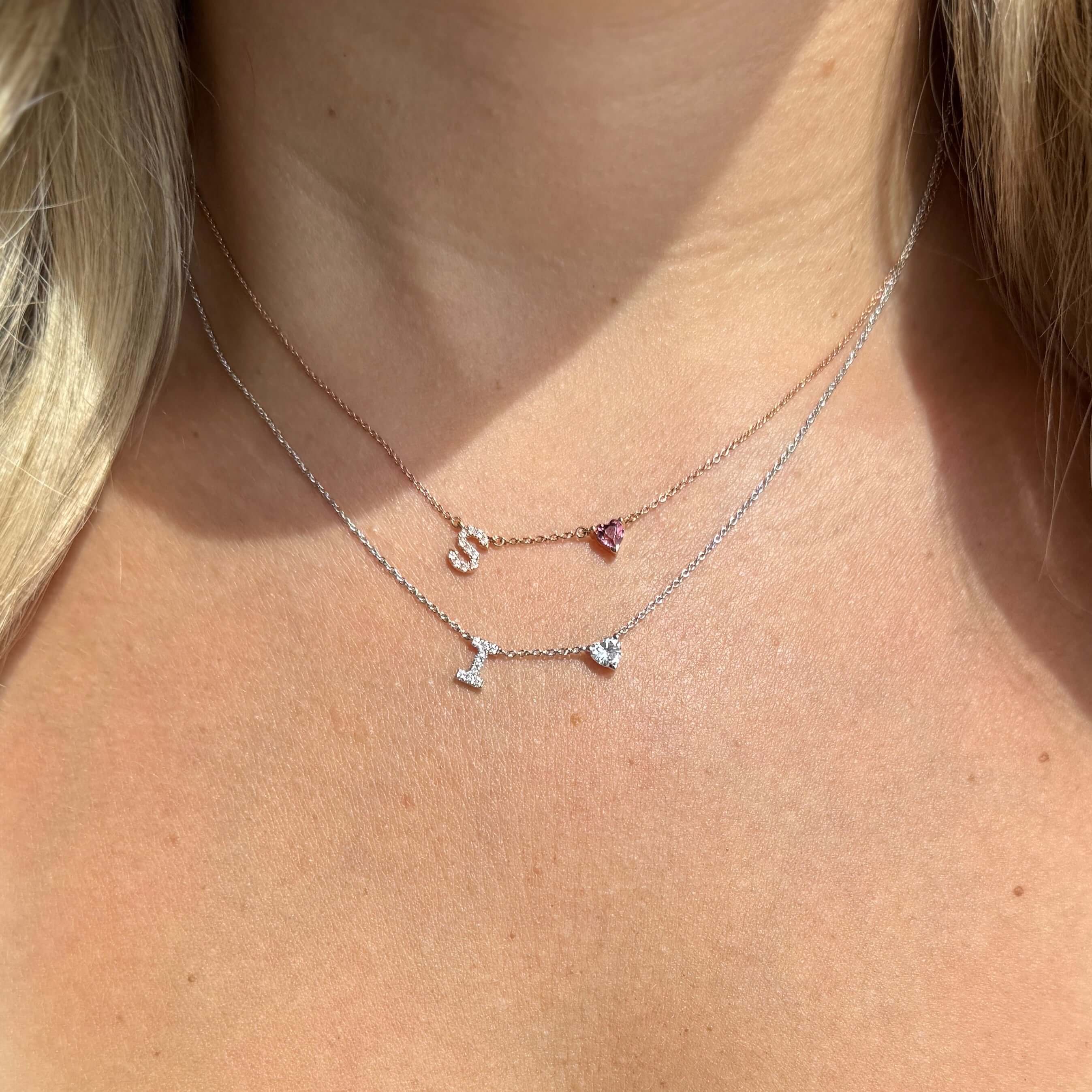 14K Gold Pave Diamond Initial Heart Gemstone Necklace worn with initial 'S' and birthstone pendant.