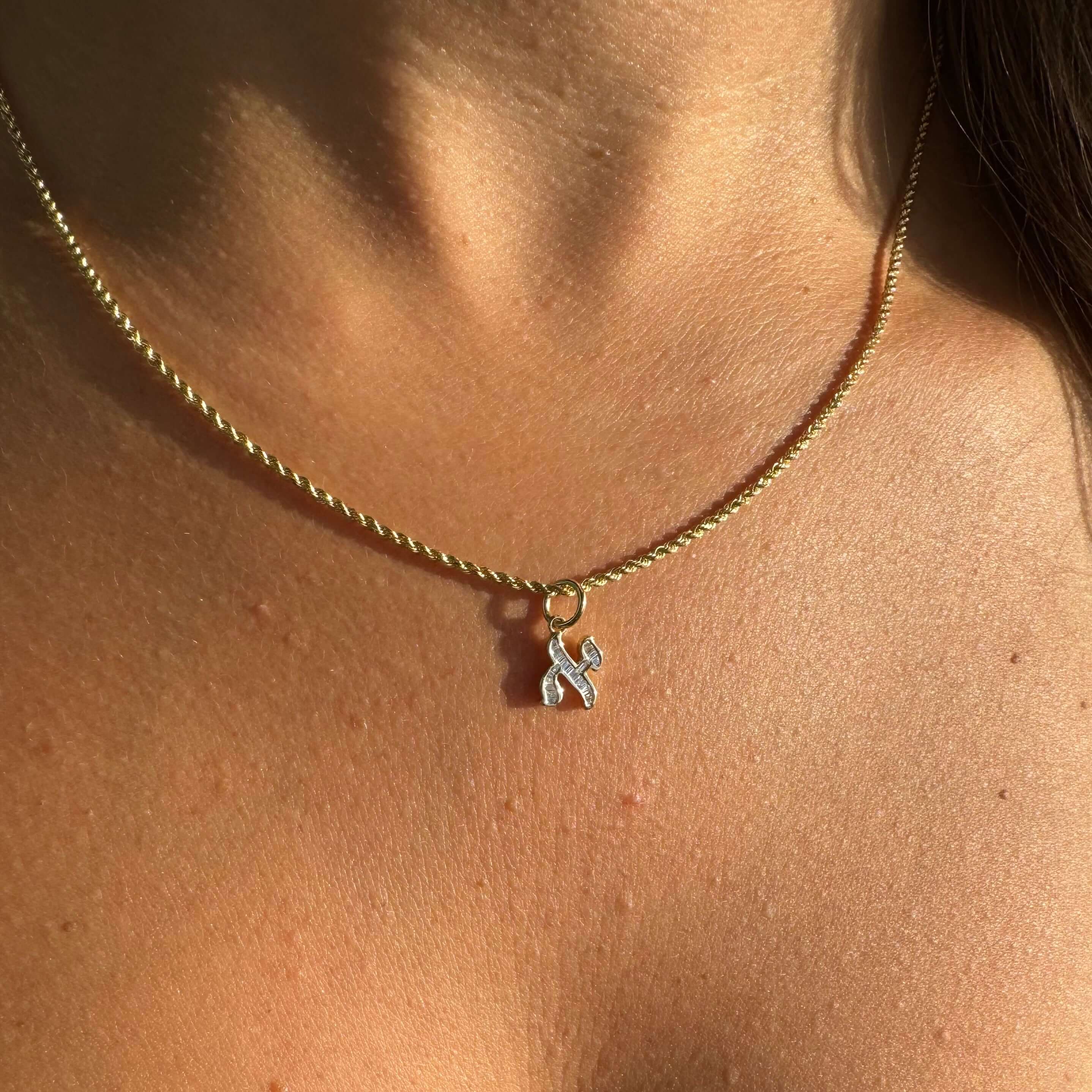 Baguette Diamond Hebrew Initial Necklace Charm featured on a model, showcasing its elegance and design by Izakov Fine Jewelry.