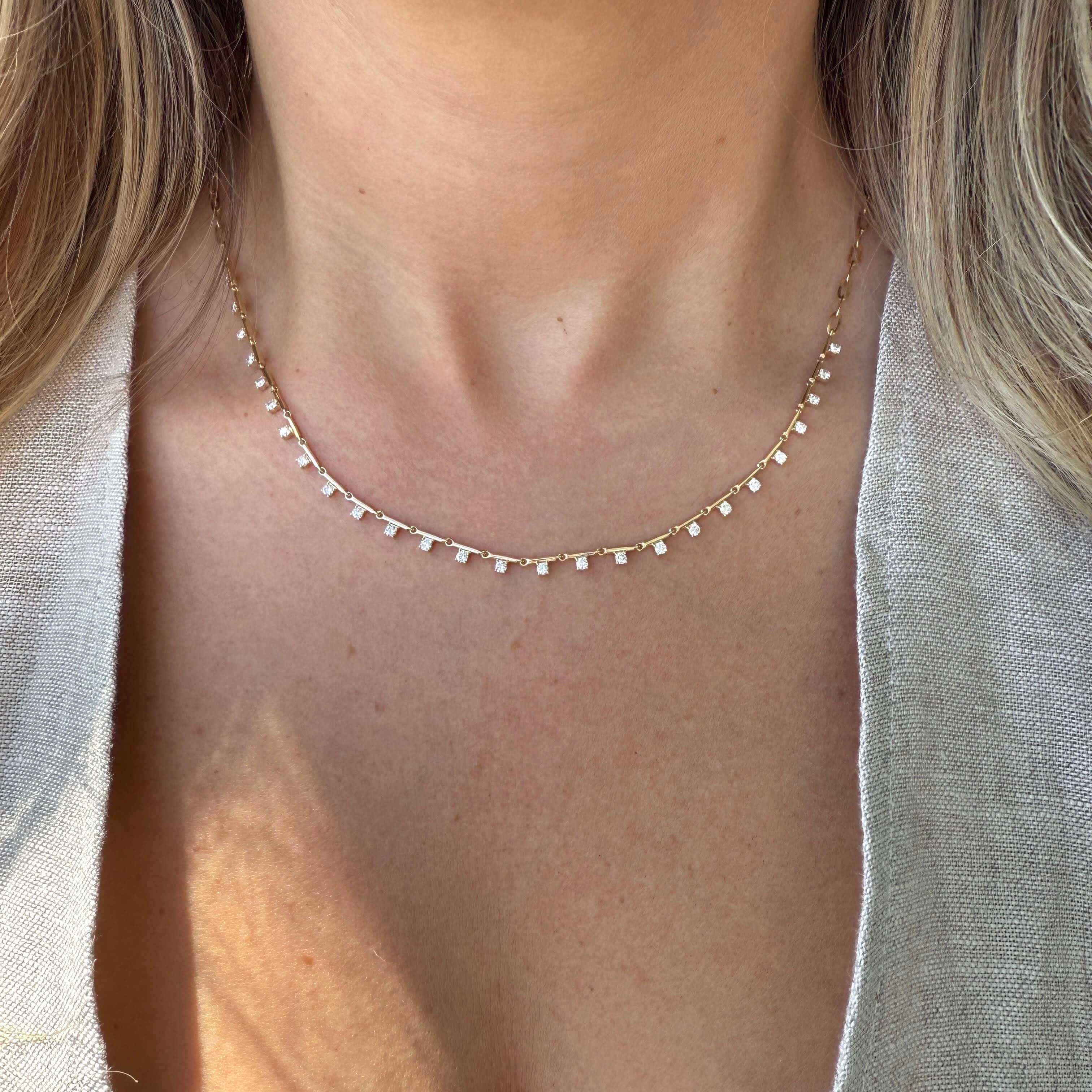 14K gold bar diamond drop station necklace worn by model, showcasing elegant design with delicate diamond drops.