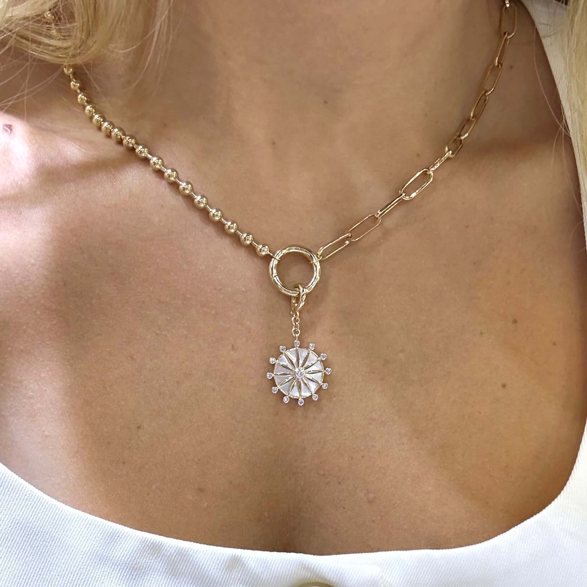 14K Gold Celestial Mother of Pearl Necklace Charm elegantly worn on the neck, showcasing its luminous design and craftsmanship.