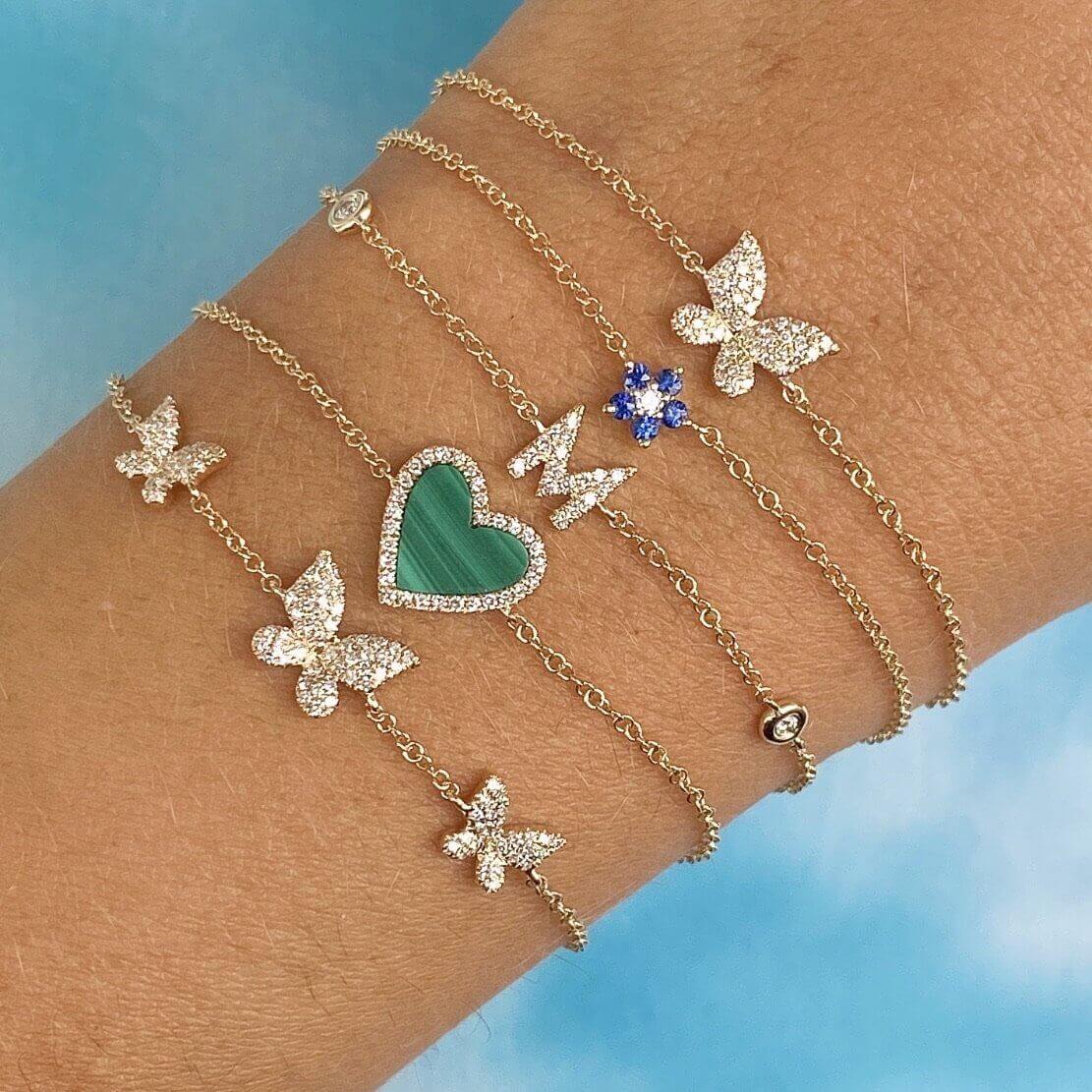 Elegant gold bracelets featuring butterfly and heart charms with crystal embellishments from our exclusive jewelry collection.