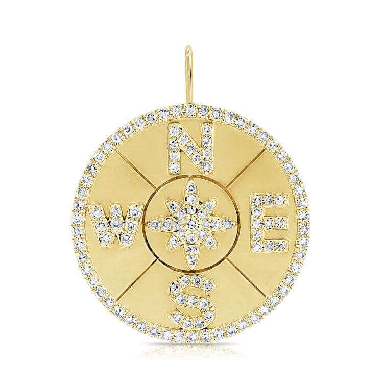 Gold compass pendant with diamond accents by our jewelry brand.