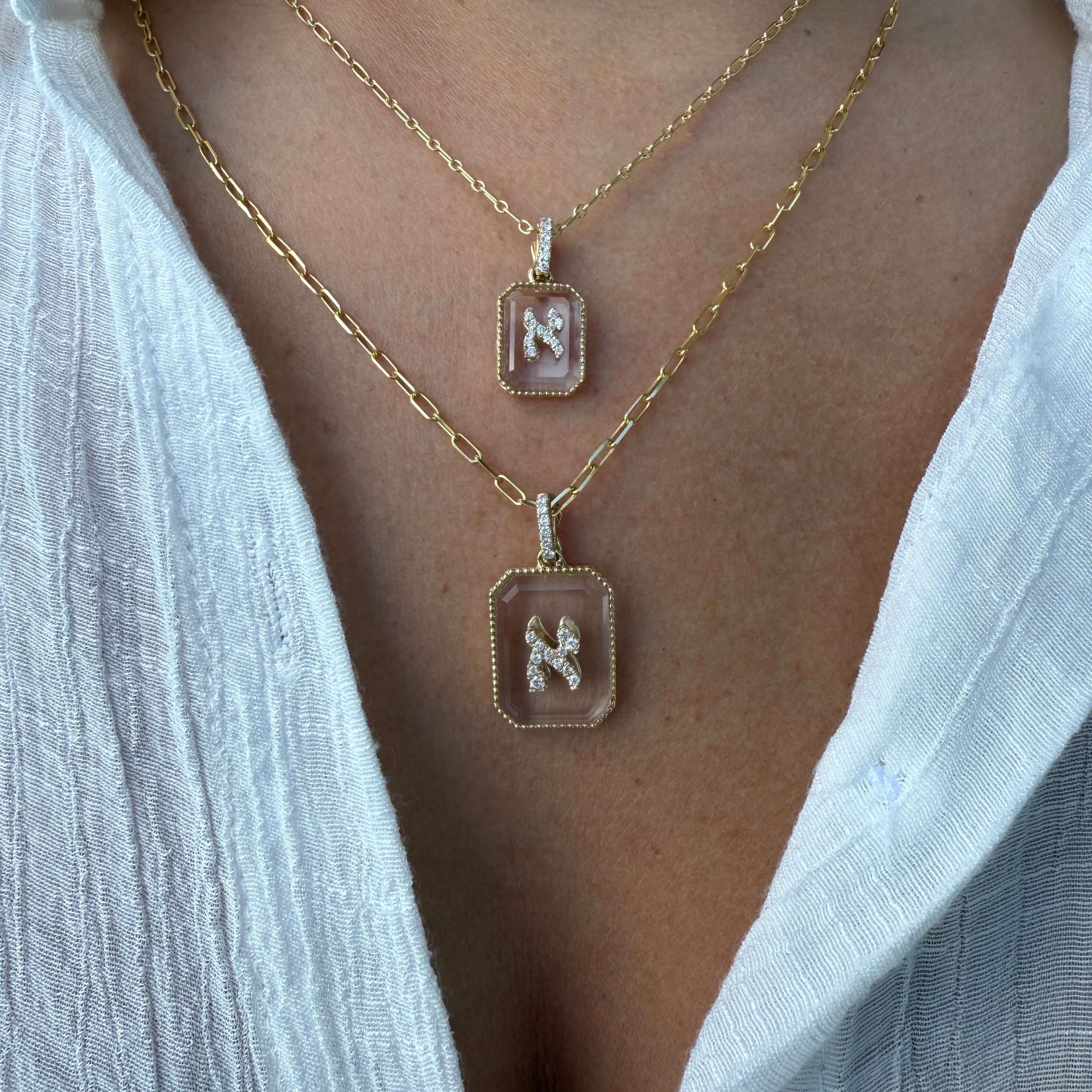 14K Gold Diamond Hebrew Initial on Crystal Pendant necklaces showcased on a model's neck.