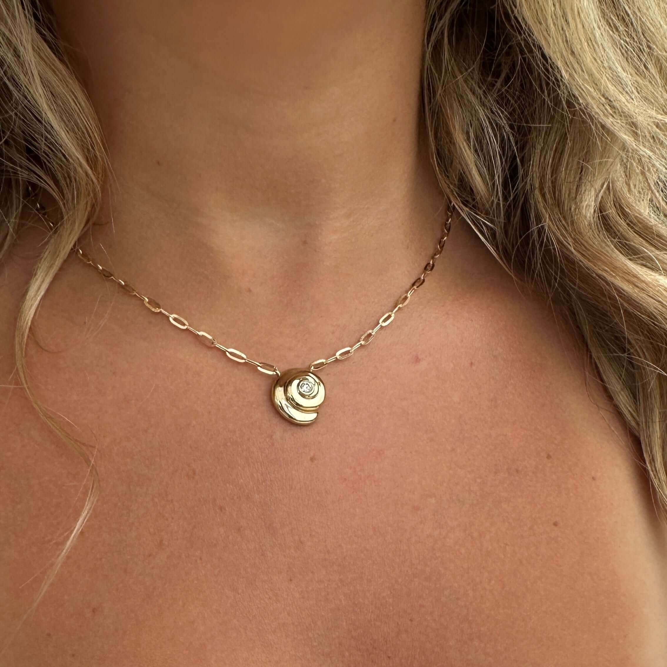 Elegant gold necklace with pendant on woman showcasing our premium jewelry collection.