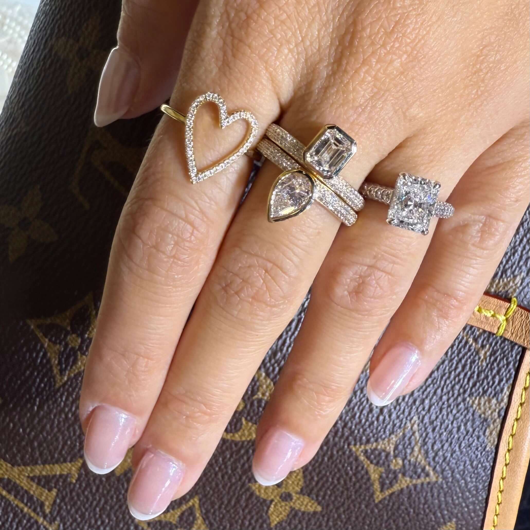 Bezel Lab Diamond Micro Pave Ring showcased on a hand with various elegant rings and a stylish background.