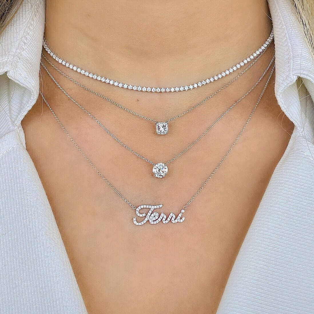 14K Gold Floating Solitaire Lab-Grown Diamond Necklace layered with sparkling chains and a personalized diamond name necklace.