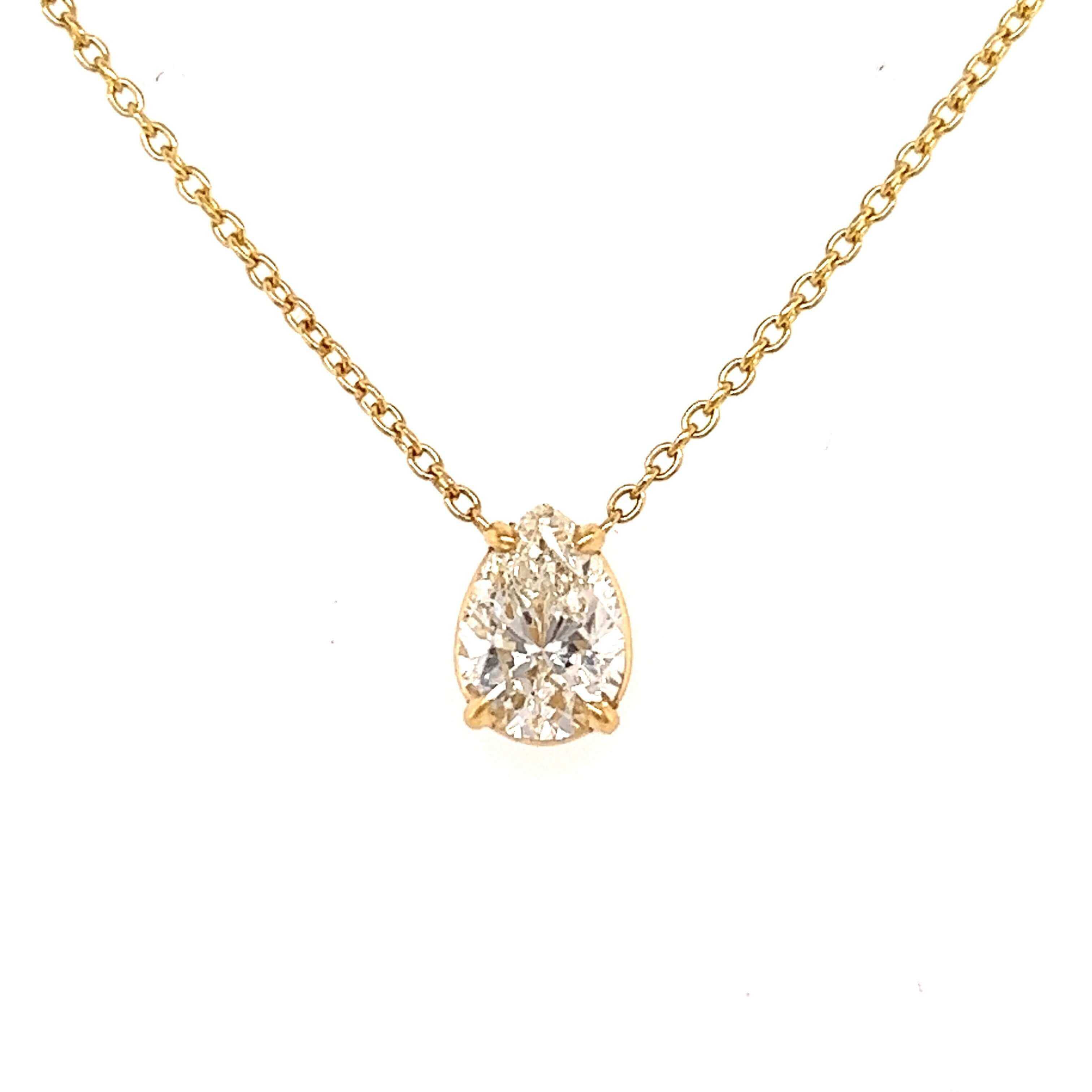 Floating Solitaire Necklace Setting with a sparkling diamond pendant on a 14K gold chain by Izakov Fine Jewelry.