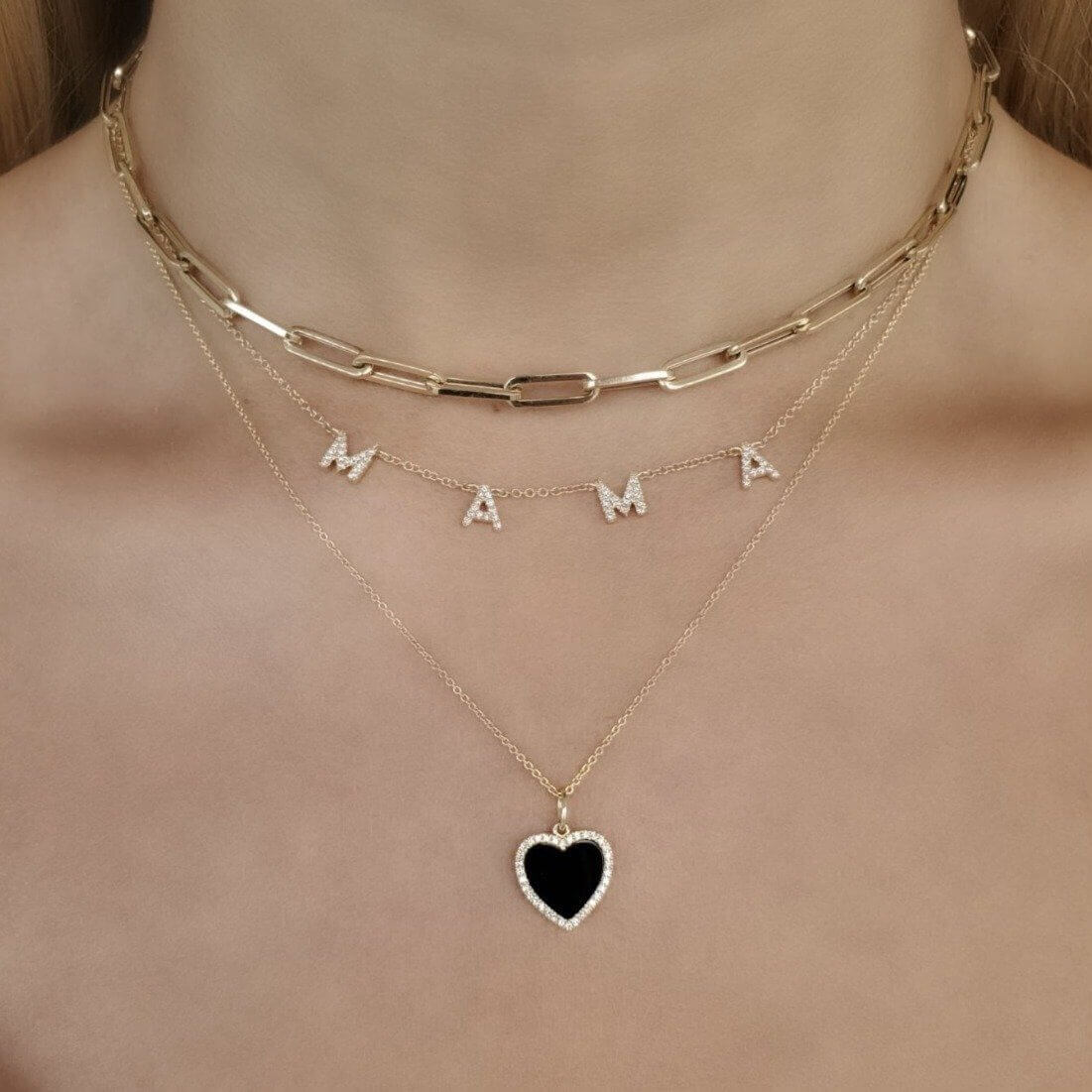 Gold layered necklace with 'MAMA' letters and heart pendant, perfect for stylish mothers, from our exquisite jewelry collection.
