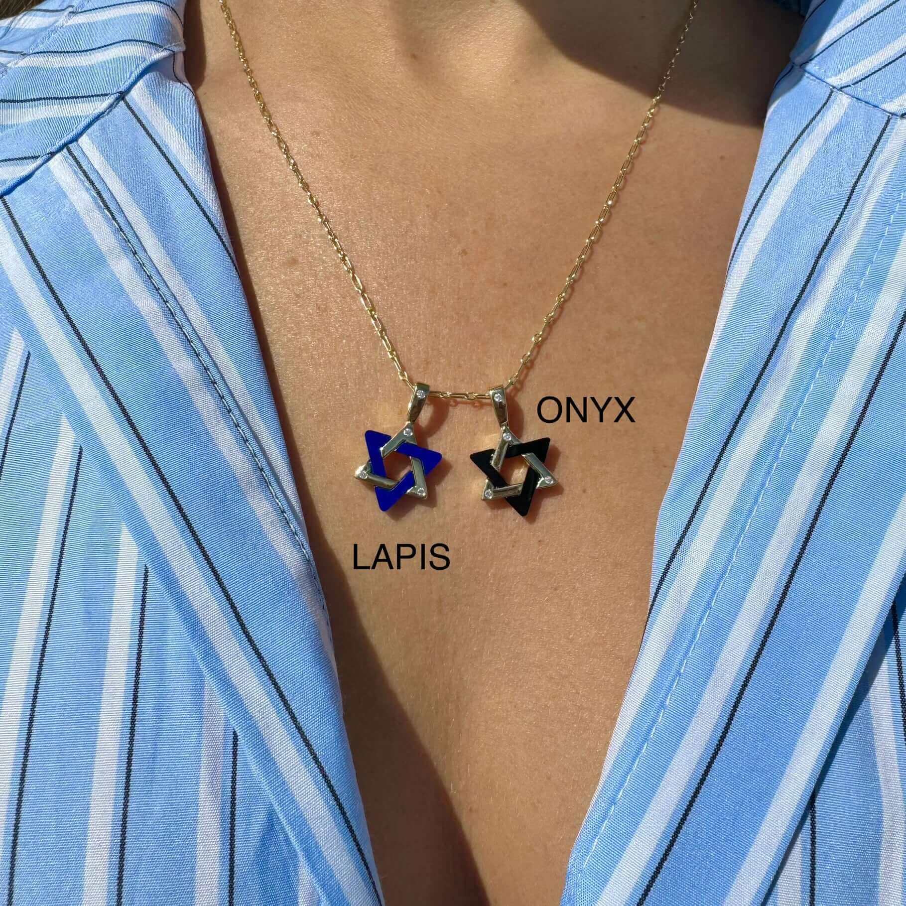 Gold necklace with lapis and onyx star pendants against a blue striped shirt from our exclusive jewelry collection
