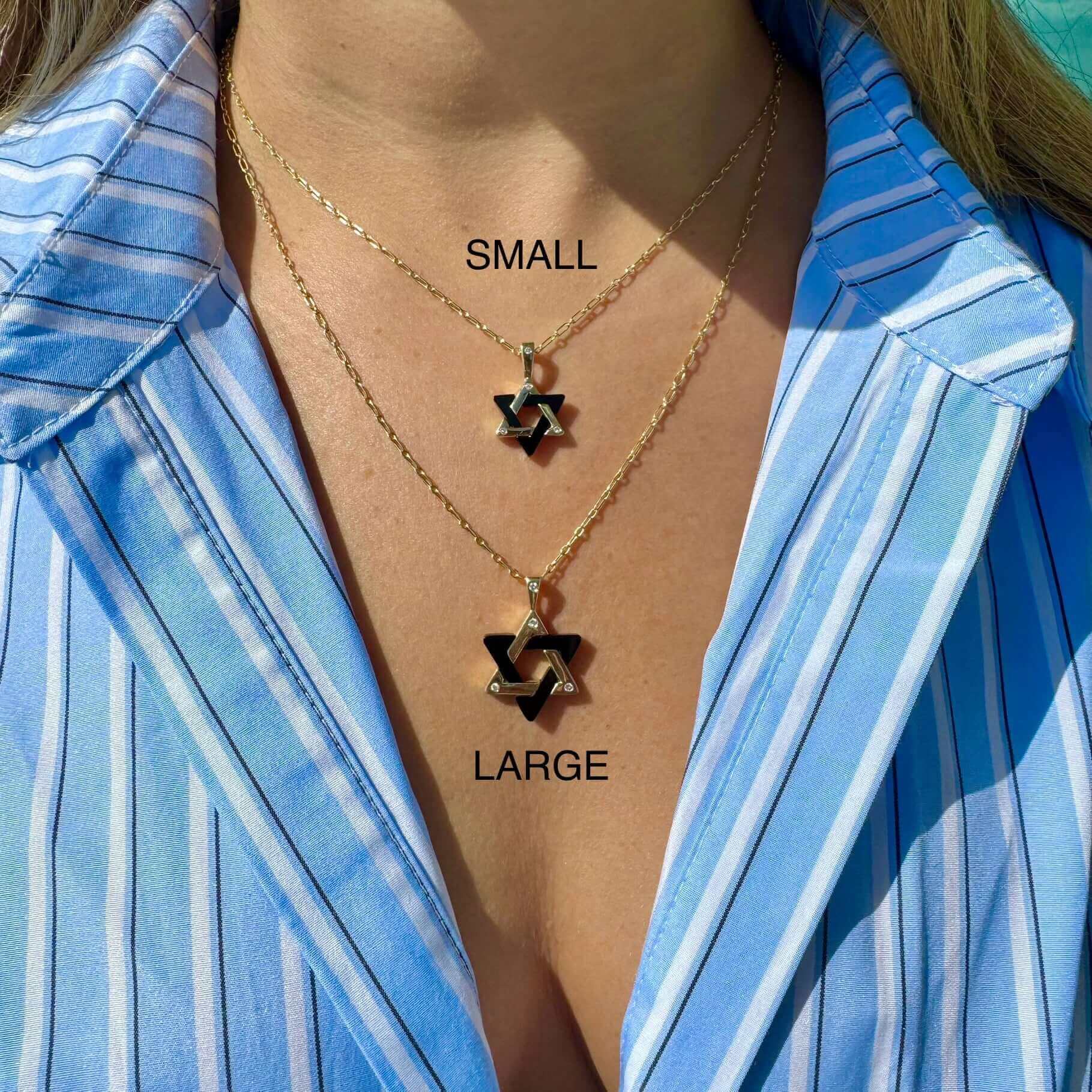 Woman wearing layered necklaces with small and large star-shaped pendants from our jewelry brand.