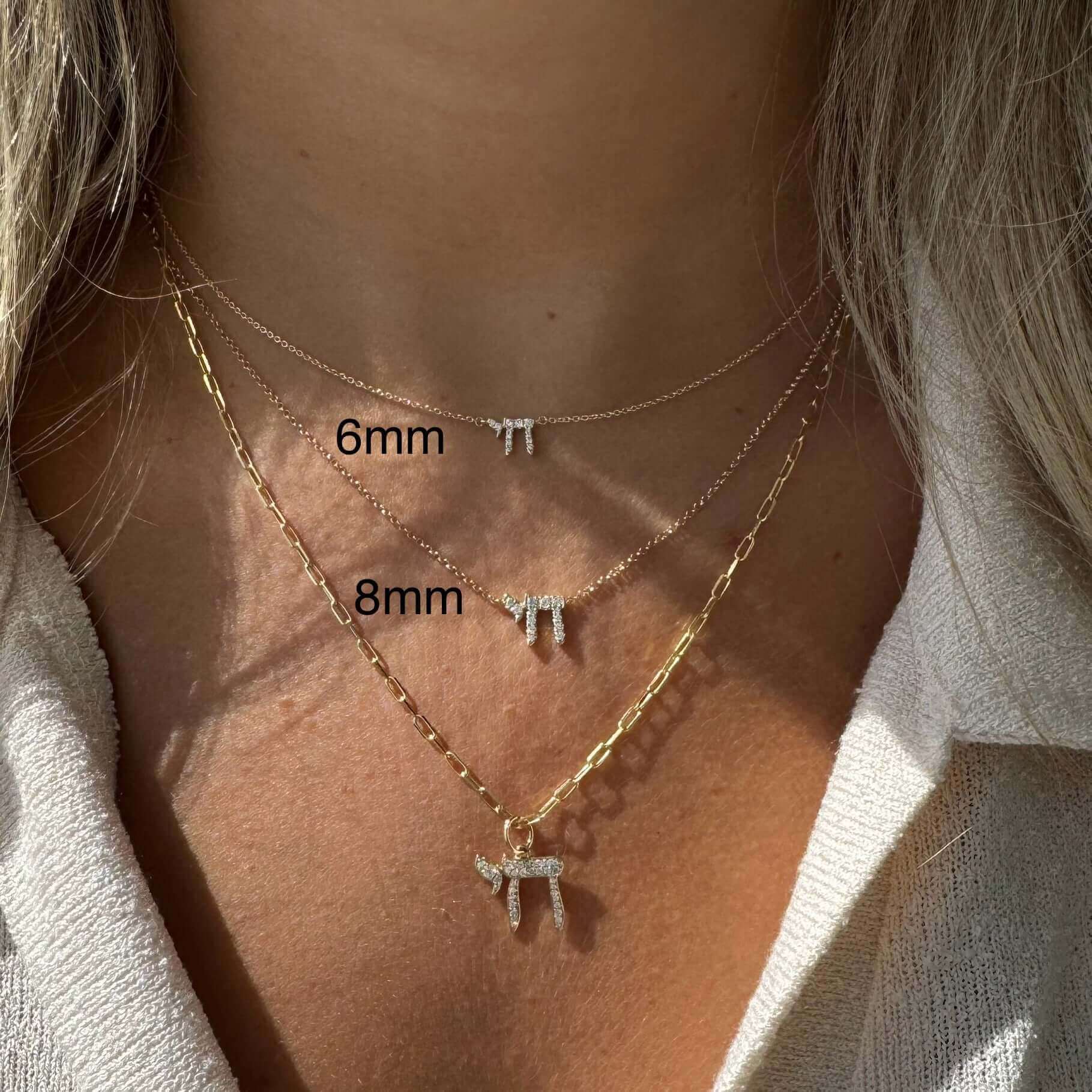 Woman wearing layered gold necklaces with dainty letter pendants showcasing sizes 6mm and 8mm from our jewelry collection