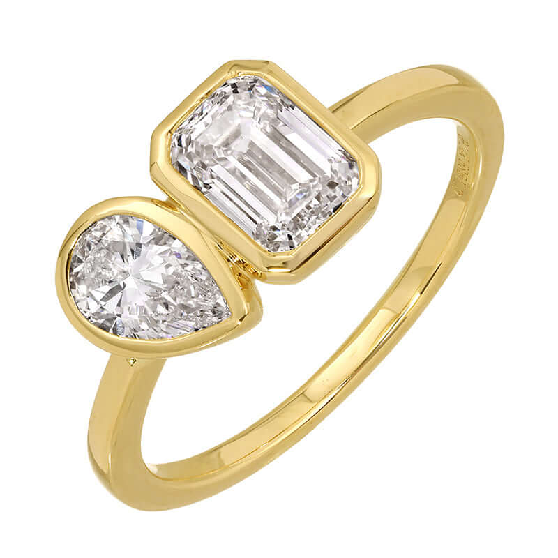 Lab Diamond Toi et Moi Bezel Ring featuring a pear-shaped diamond and an emerald-cut diamond in 14k gold.