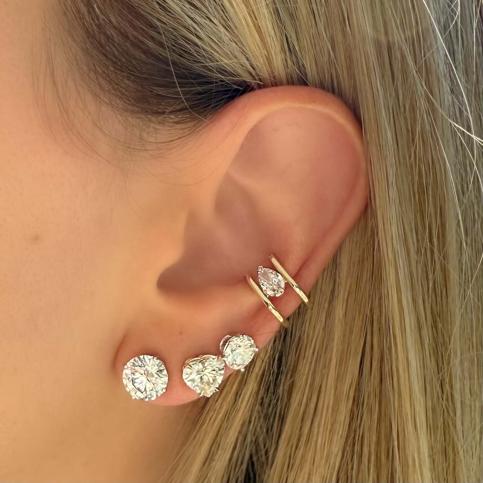 14K Gold Lab Grown Pear Diamond Ear Cuff worn alongside sparkling earrings, showcasing modern jewelry design.