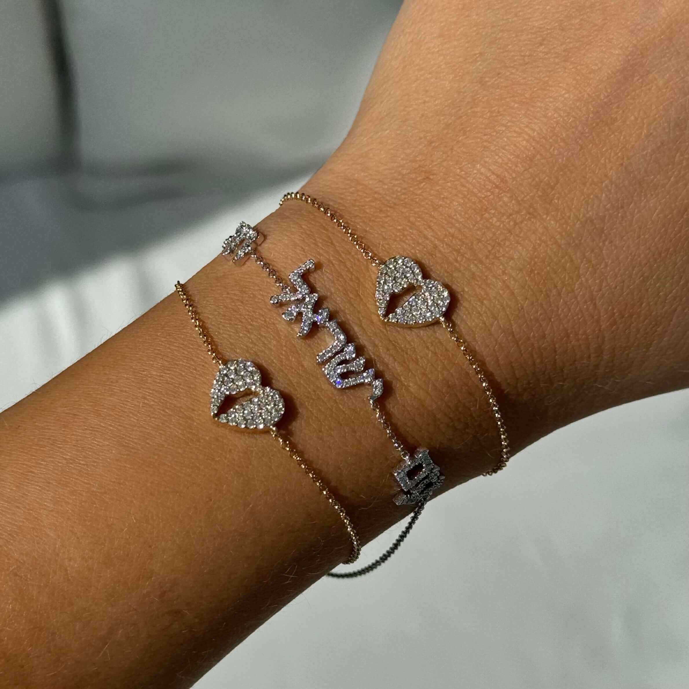 14K Gold Land Of Israel Cutout Heart Pave Diamond Bracelet © worn on a wrist showcasing its elegant design.