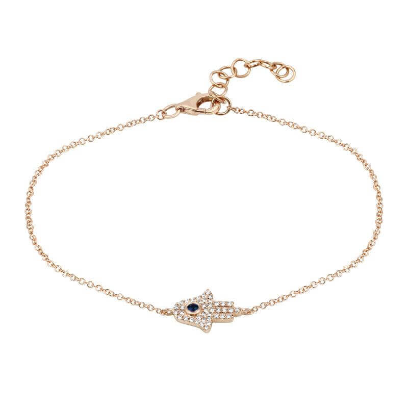 Gold bracelet with Hamsa hand and blue gem by our jewelry brand