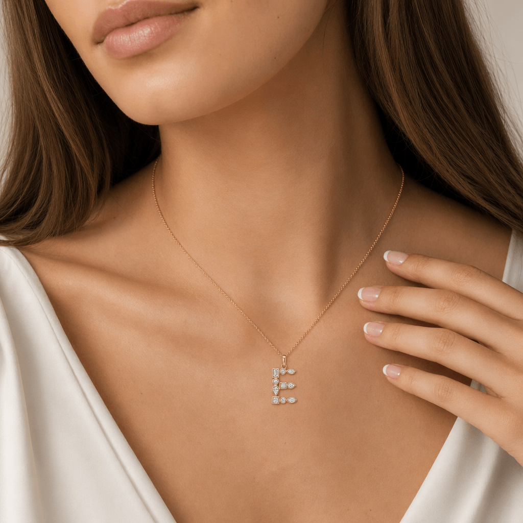 Model wearing a Multi Shape Diamond Initial Pendant in gold, featuring an elegant diamond 'E' design.