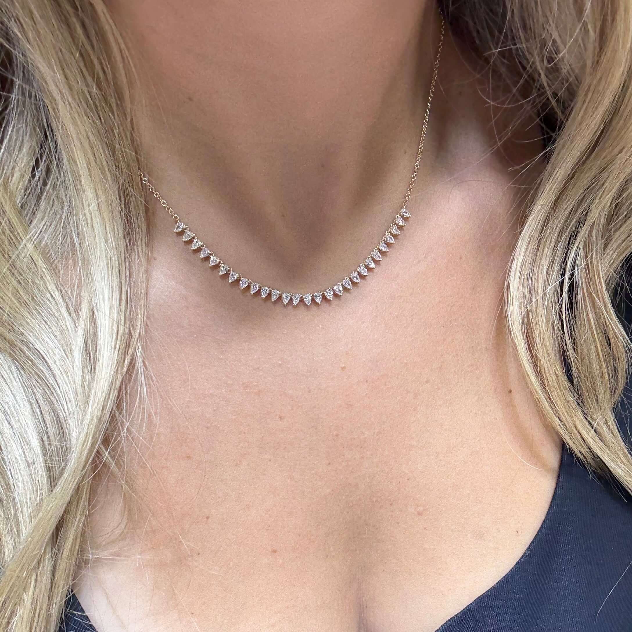 14K Gold Pear Shaped Diamonds Necklace featuring pear-shaped diamonds elegantly set on a delicate chain.