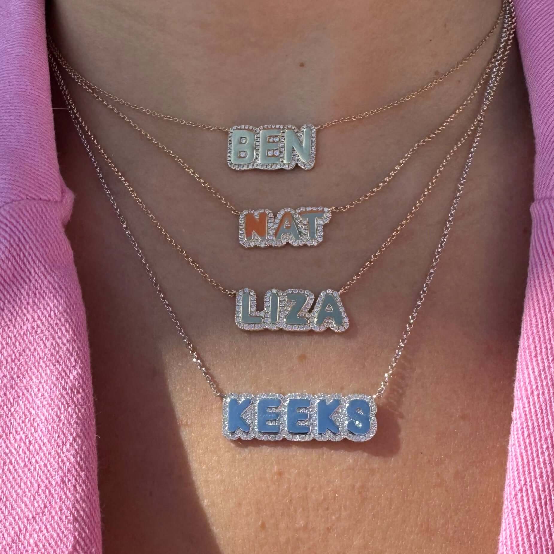 Personalized layered nameplate necklaces in silver featuring names Ben, Nat, Liza, and Keeks on a model.