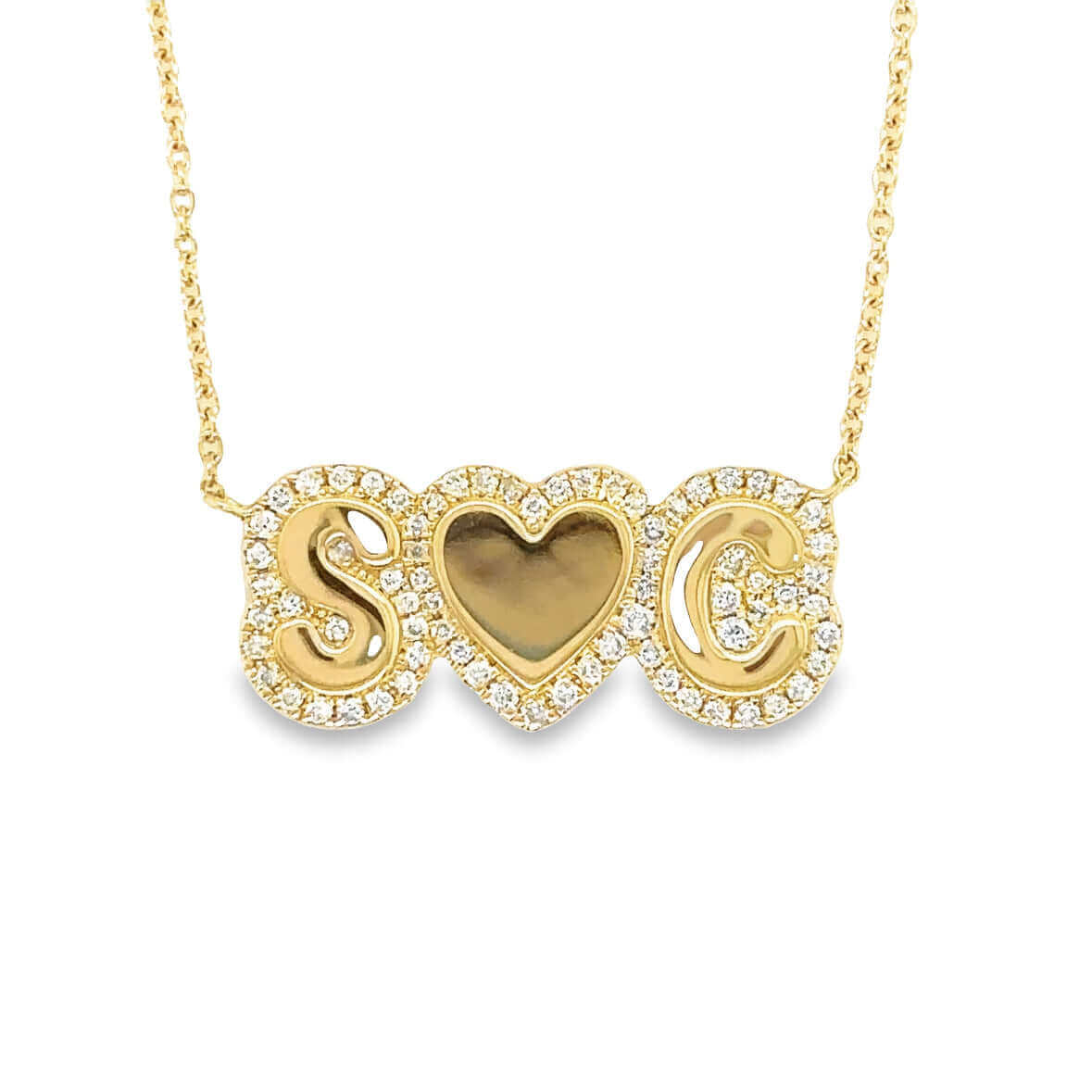 Elegant gold necklace with initials S and C, featuring heart-shaped central charm, surrounded by sparkling gemstones, perfect for personalized jewelry lovers.