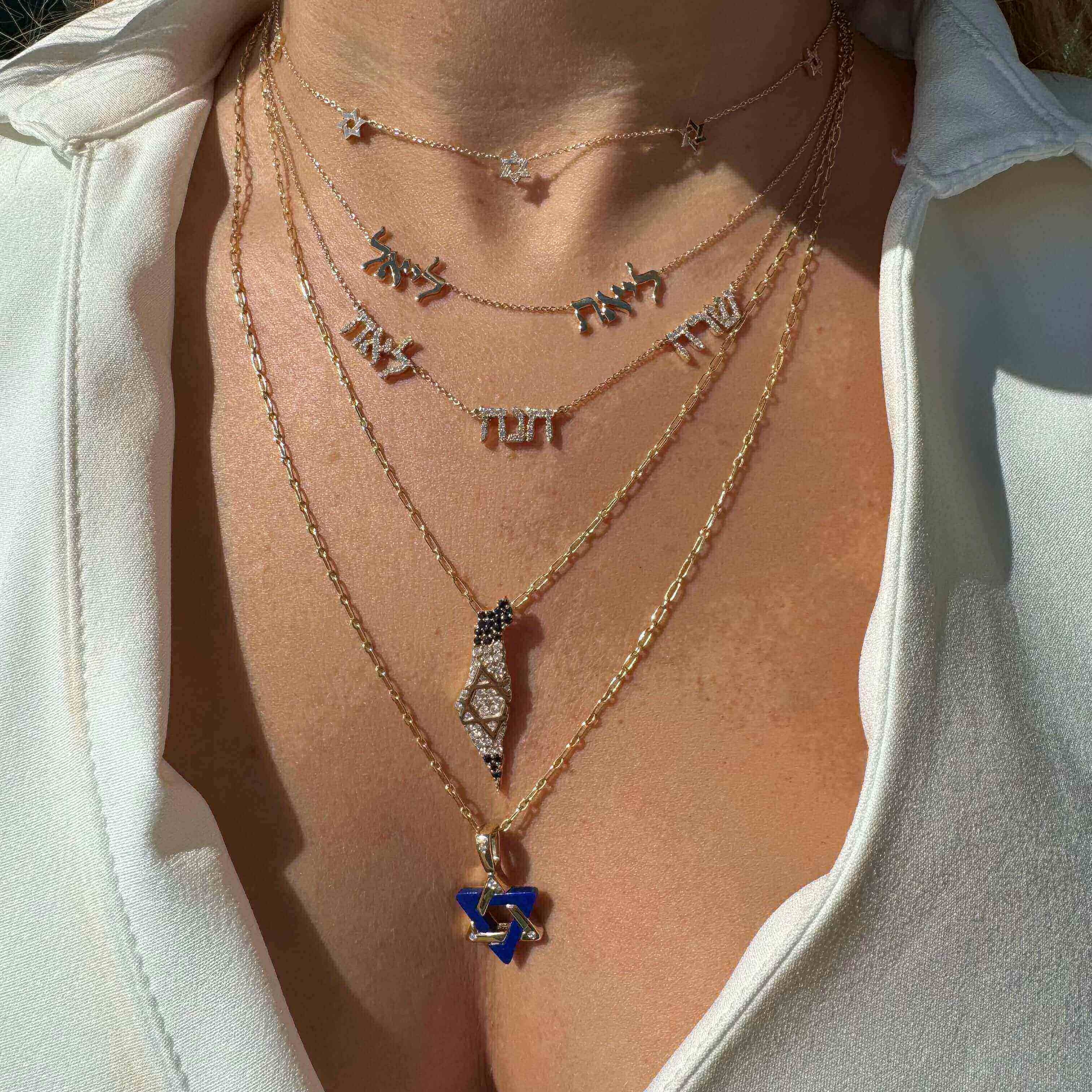 Personalized Multiple Hebrew Diamond Nameplate Necklace layered with Hebrew letters and a Star of David in gold.