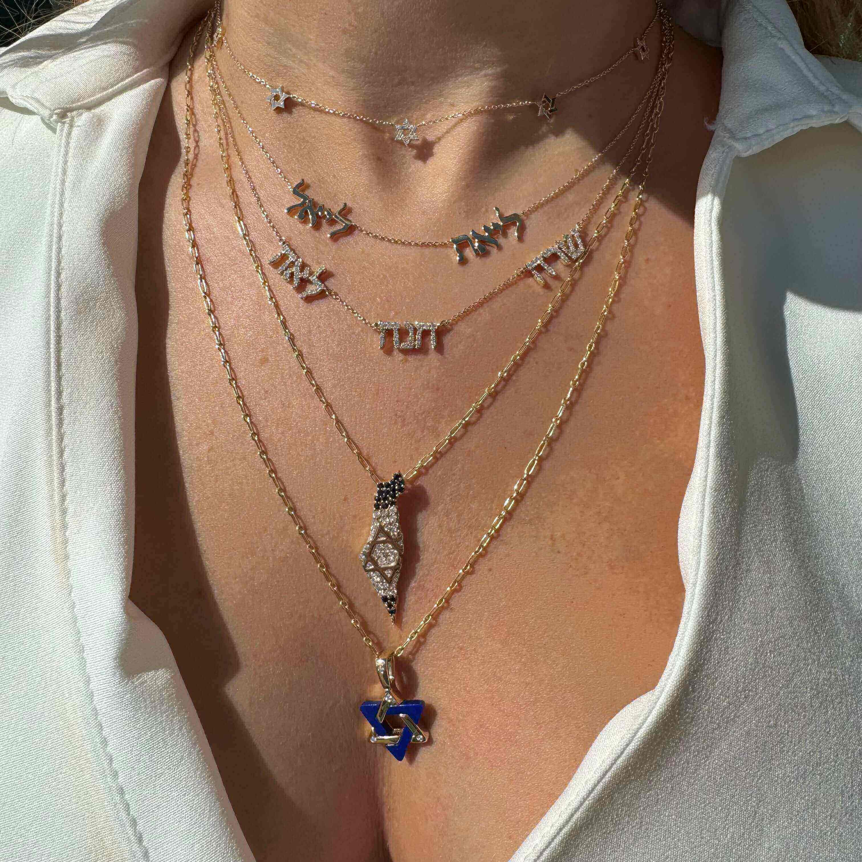 Personalized Multiple Hebrew Diamond Nameplate Necklace layered with Hebrew letters and a Star of David in gold.