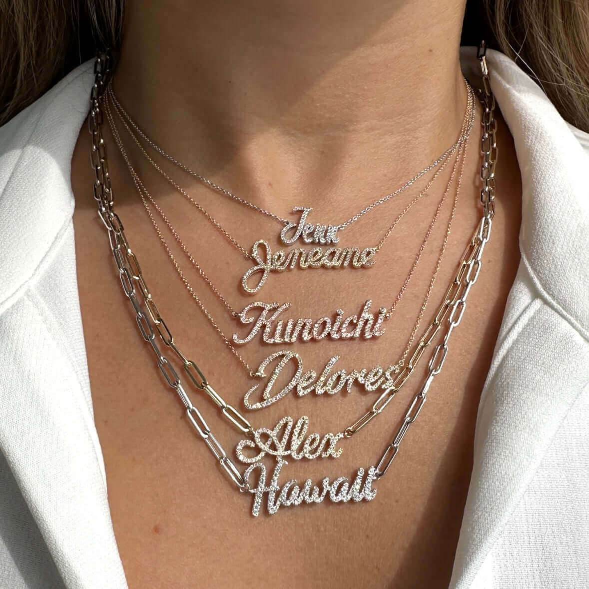 Personalized Script Nameplate Diamond Necklace displayed on model with multiple nameplate styles and silver chains.