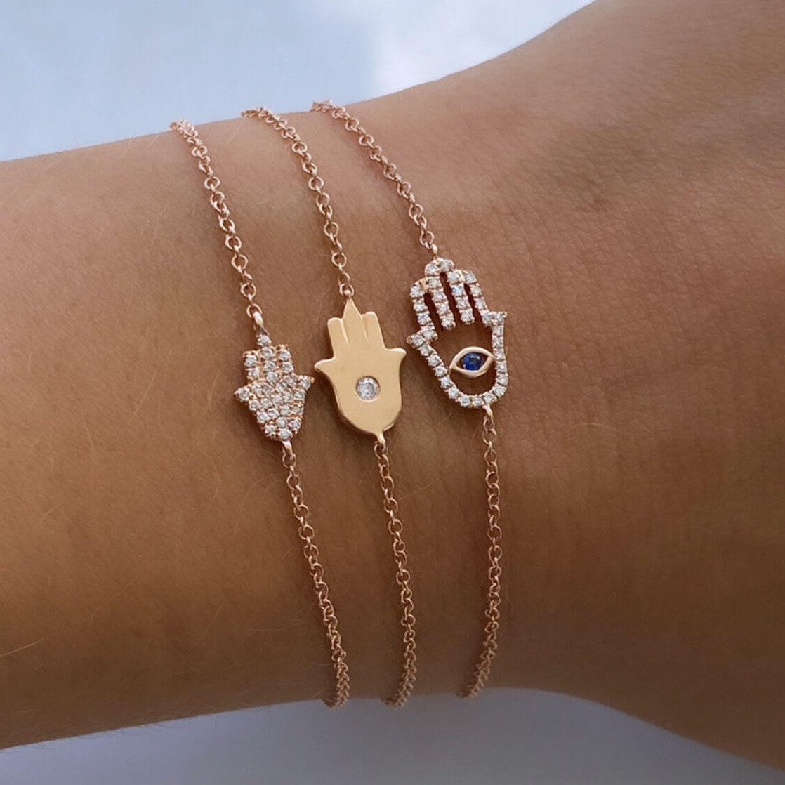 Rose gold Hamsa bracelets with gems on wrist