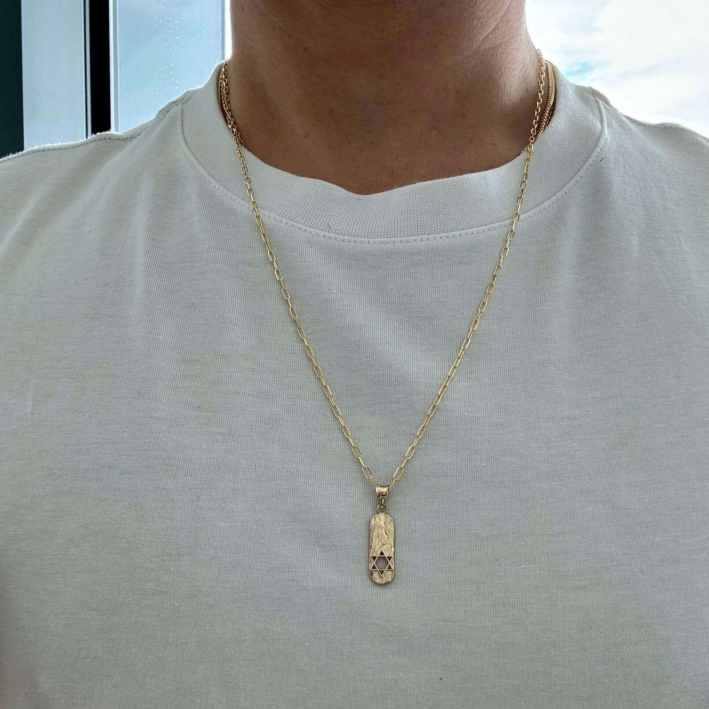Star Of David Mezuzah Gold Pendant worn on a gold chain, showcasing its beautiful design and elegance.
