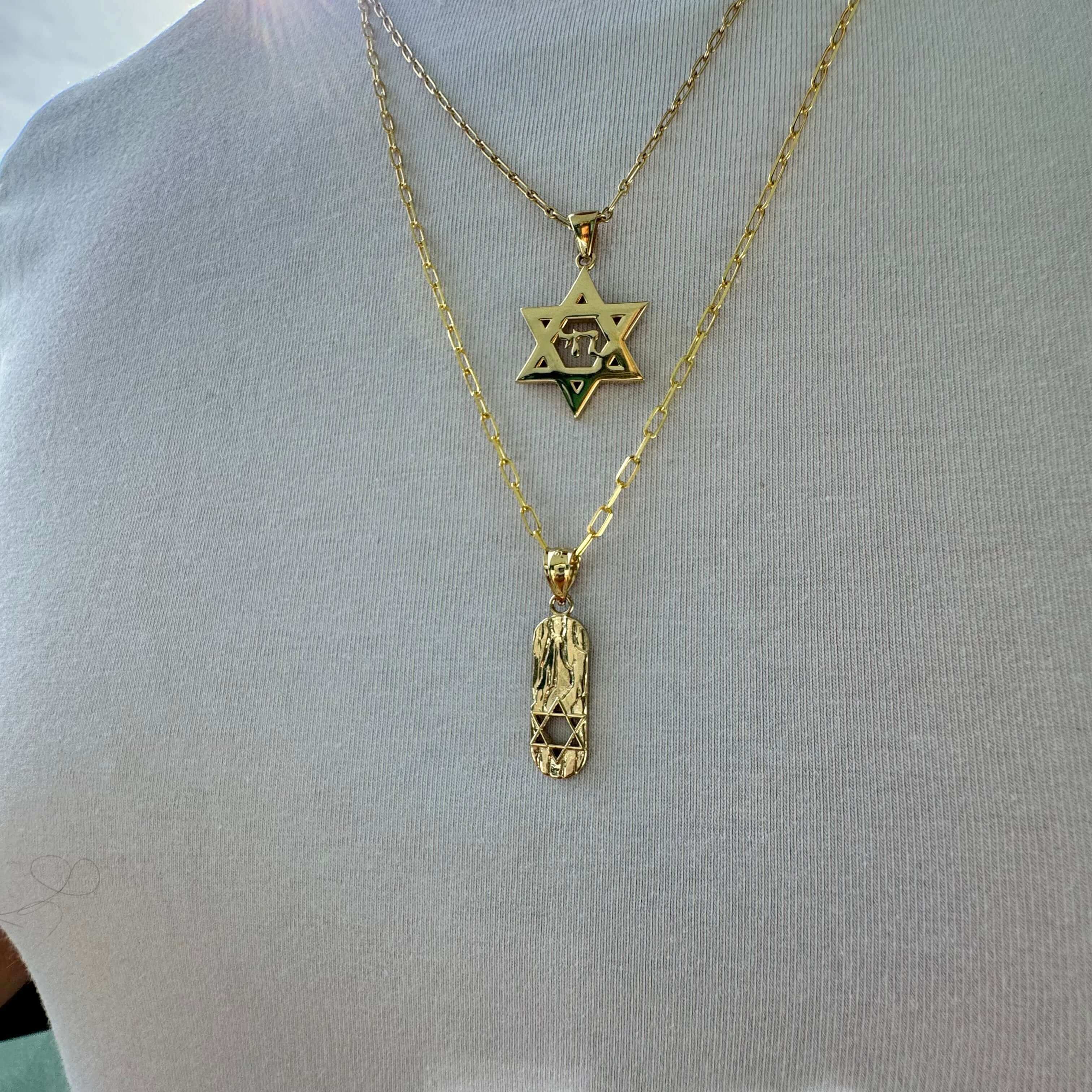 Gold Star of David and Amulet Necklaces on Display