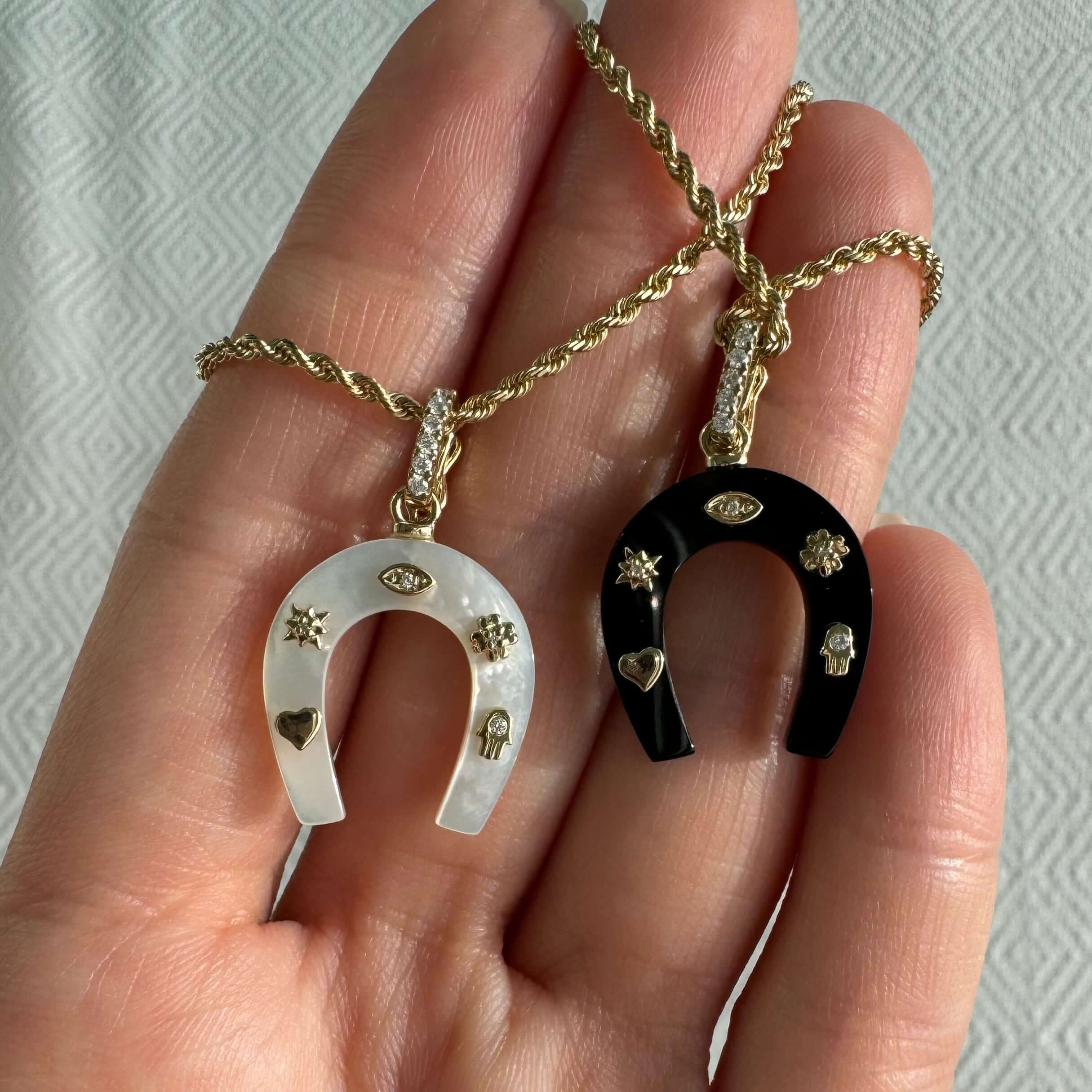 14K Gold Lucky Charms Horseshoe Gemstone Pendant © featuring white and black gemstone designs with diamond accents.