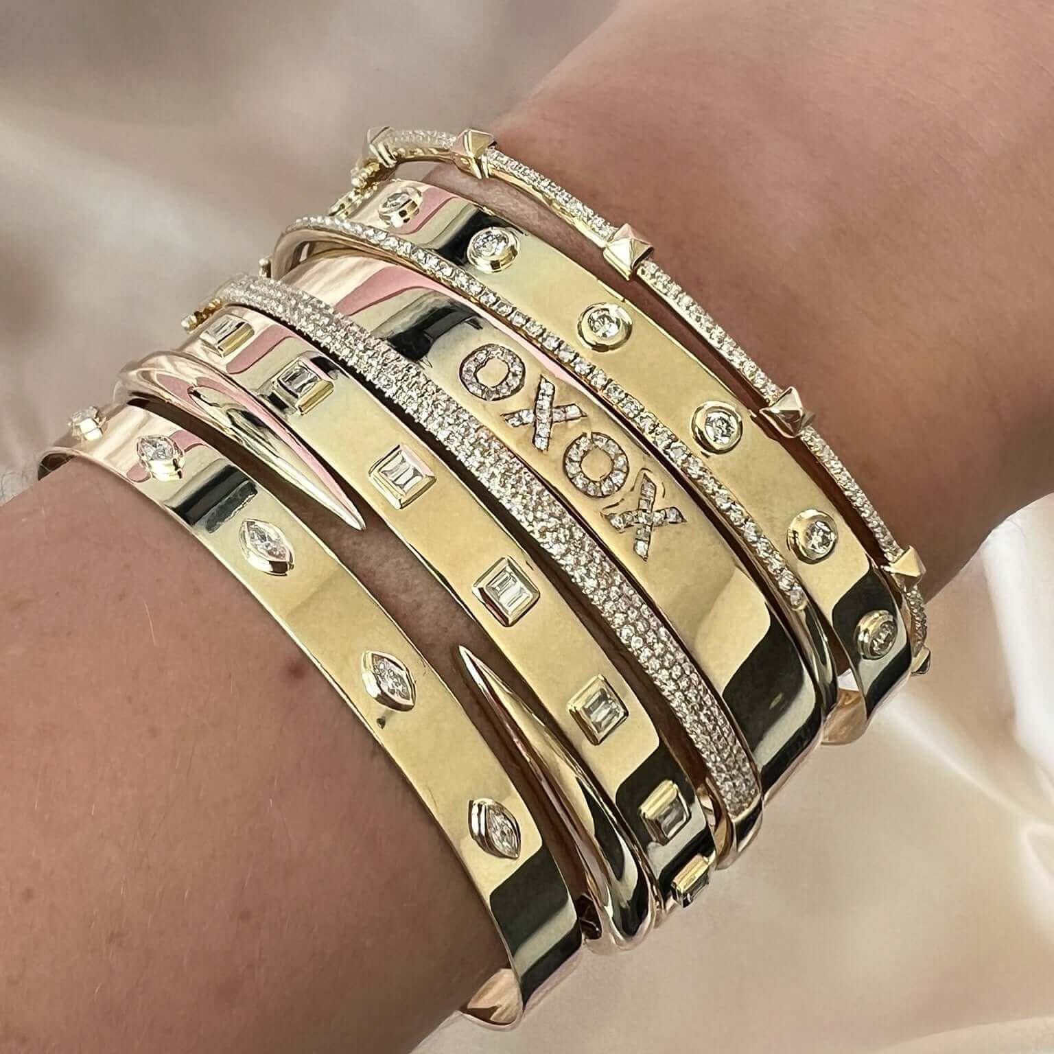 Elegant gold bracelets featuring diamonds and unique designs by Izakov Fine Jewelry.