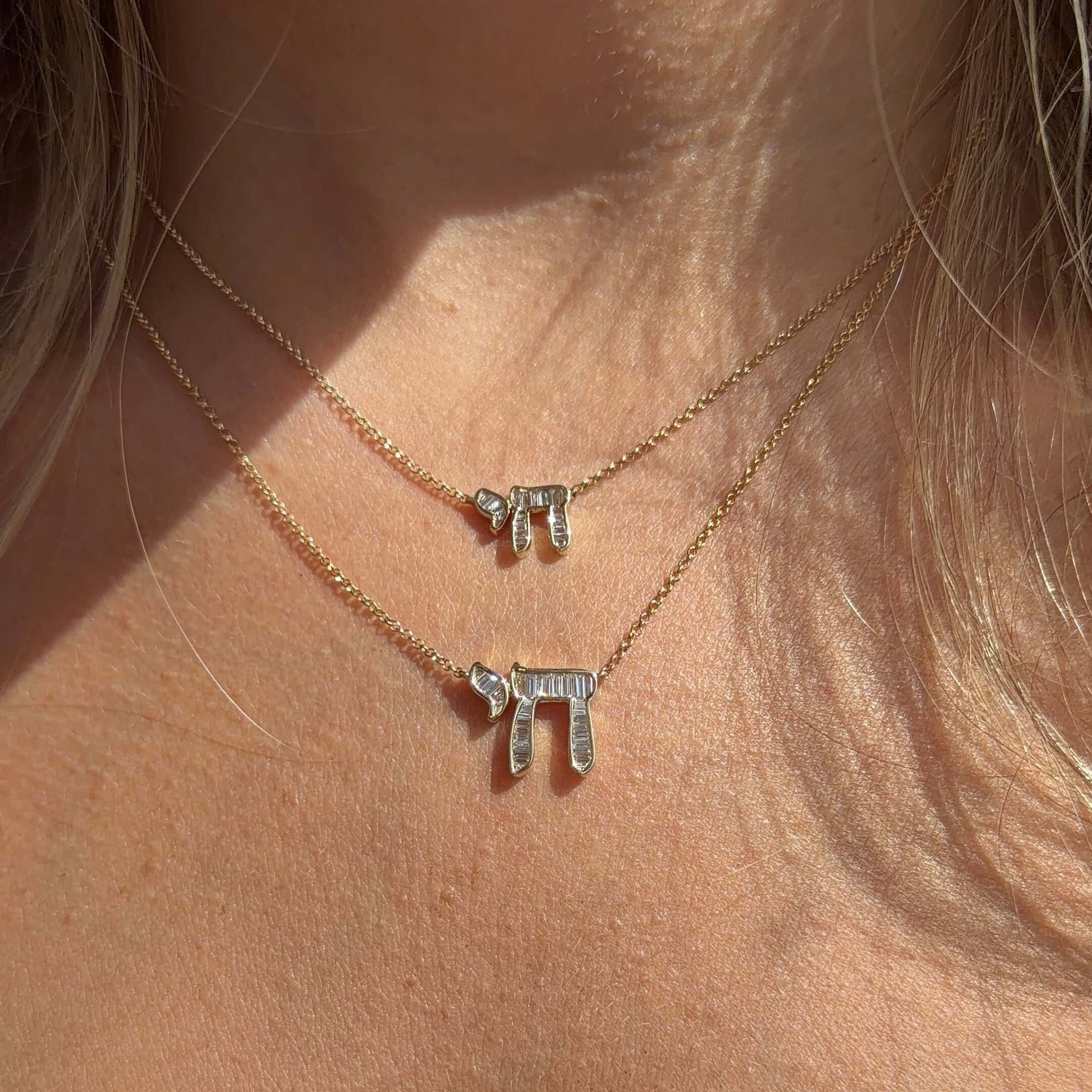 Hebrew Chai Baguette Diamond Necklace showcased on a model, highlighting its elegant design in 14K gold with baguette diamonds.