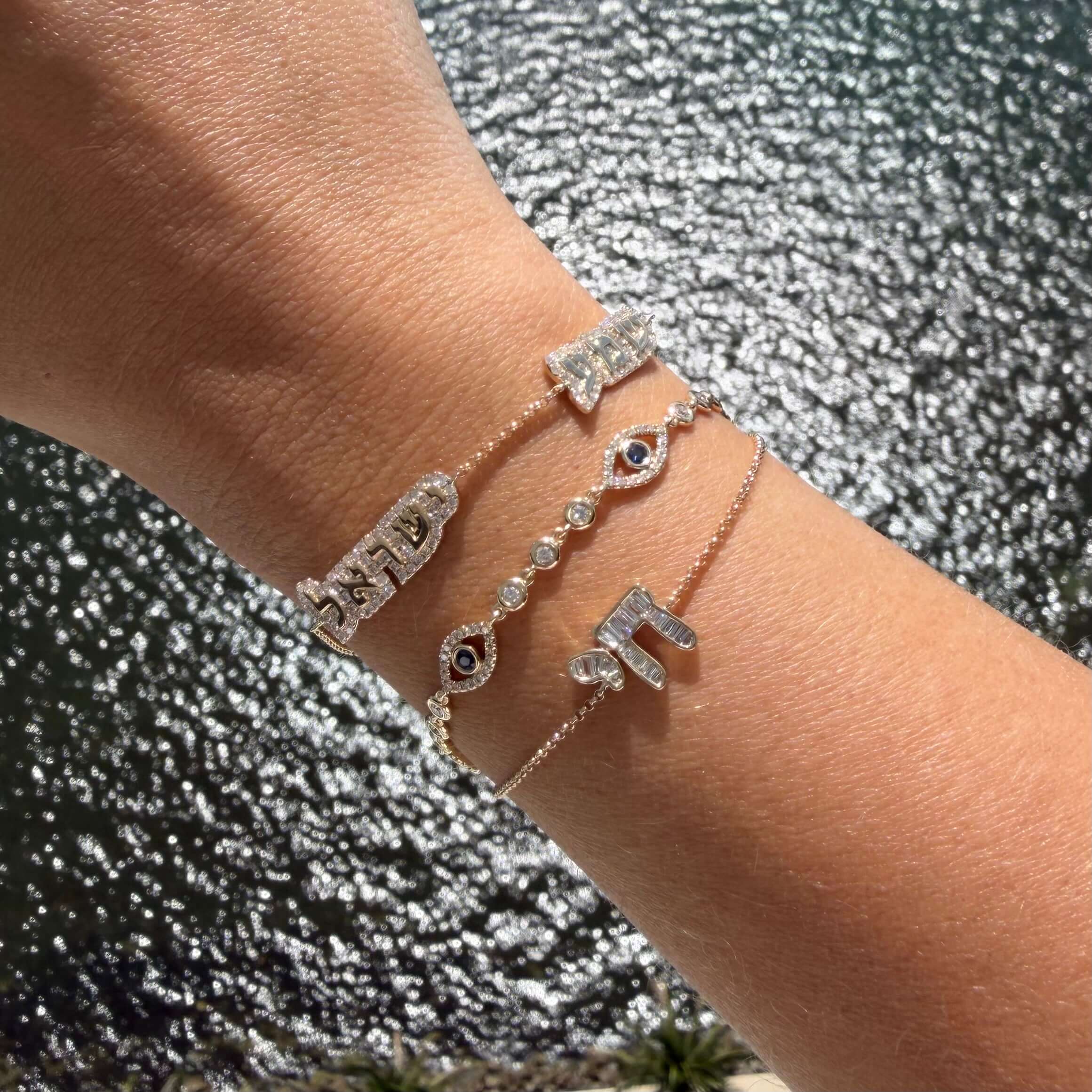 Shema Yisrael Cloud Diamond Bracelet adorned with delicate symbols and diamonds on a wrist.