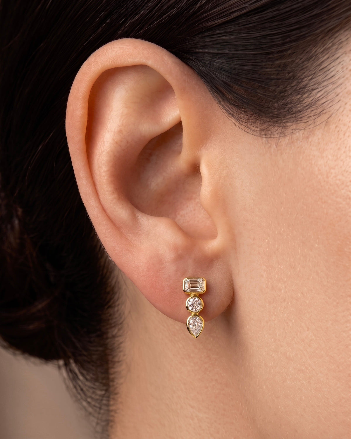 East West Emerald Cut and Pear Diamond Bezel Drop Earrings in 14k yellow gold