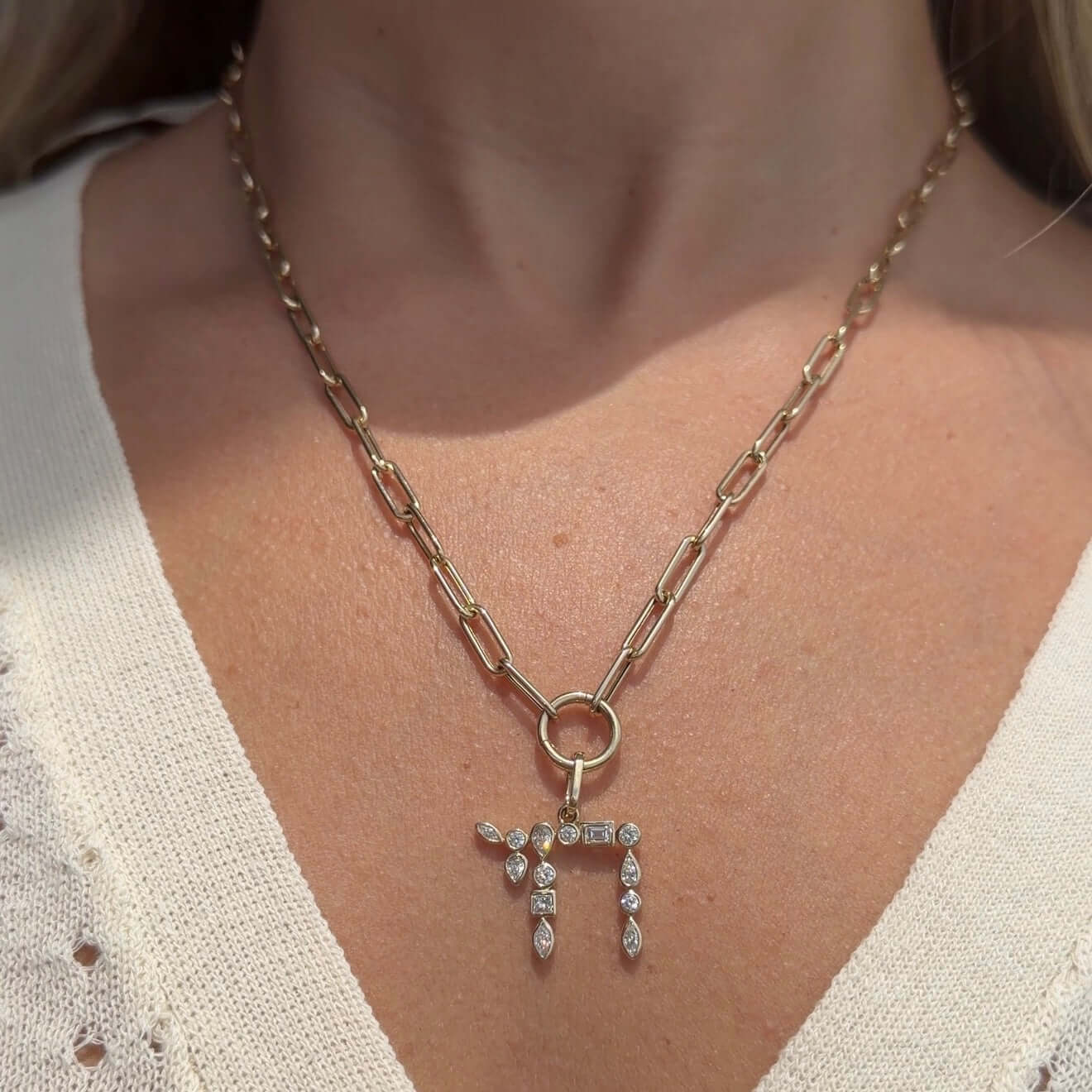 Model wearing the Hebrew Chai Multi Shape Diamond Pendant © on a gold chain necklace, showcasing its unique sparkle.