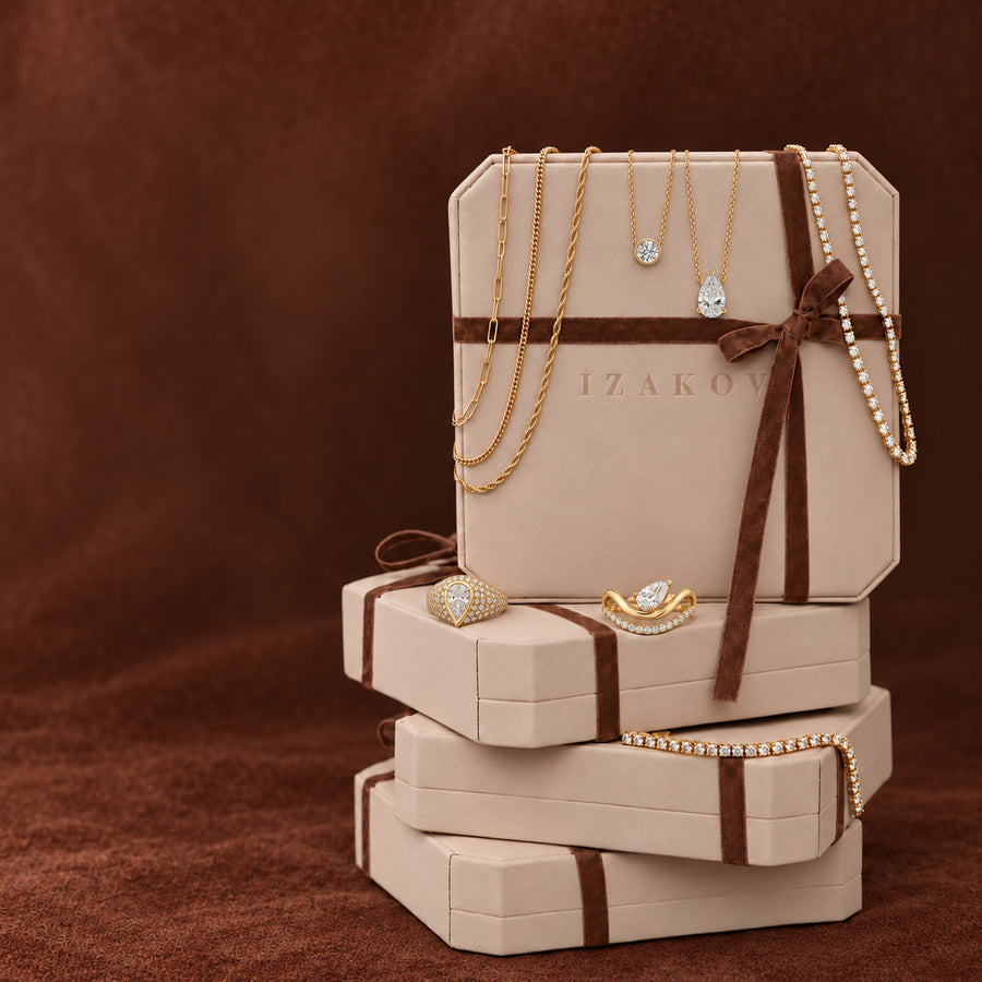 Izakov gift boxes with brown velvet ribbon, 14K gold chains, diamond pendants, pear diamond rings and a tennis bracelet