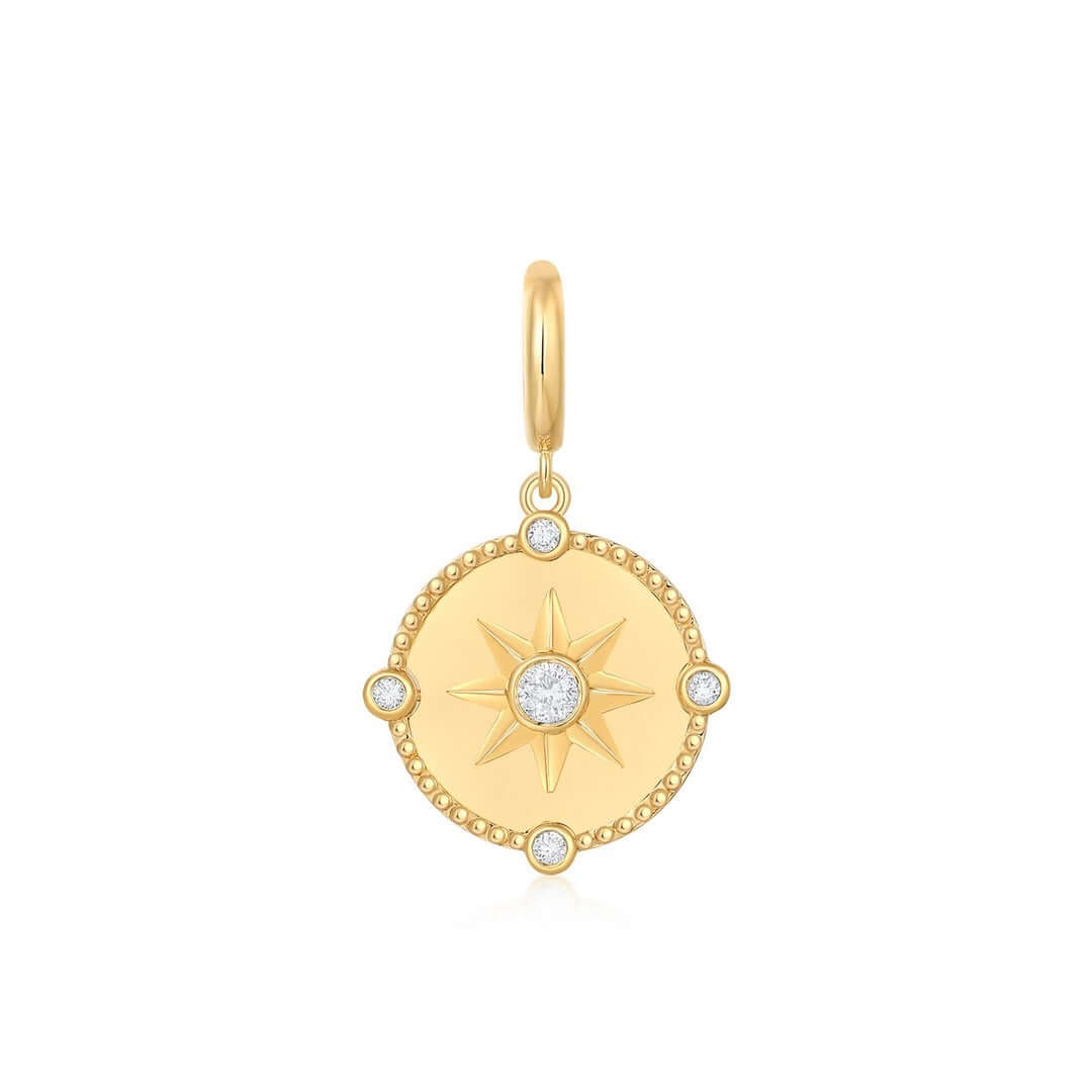 Diamond Compass Coin Charm featuring a starburst design and diamond accents on a polished gold medallion.