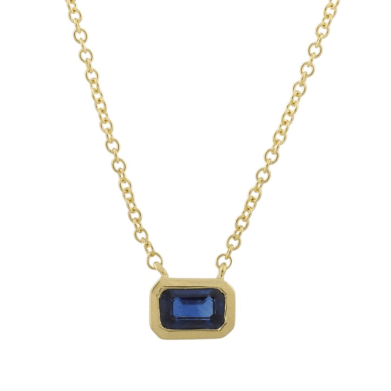 Gold chain necklace with a rectangular blue sapphire pendant from our luxury jewelry collection