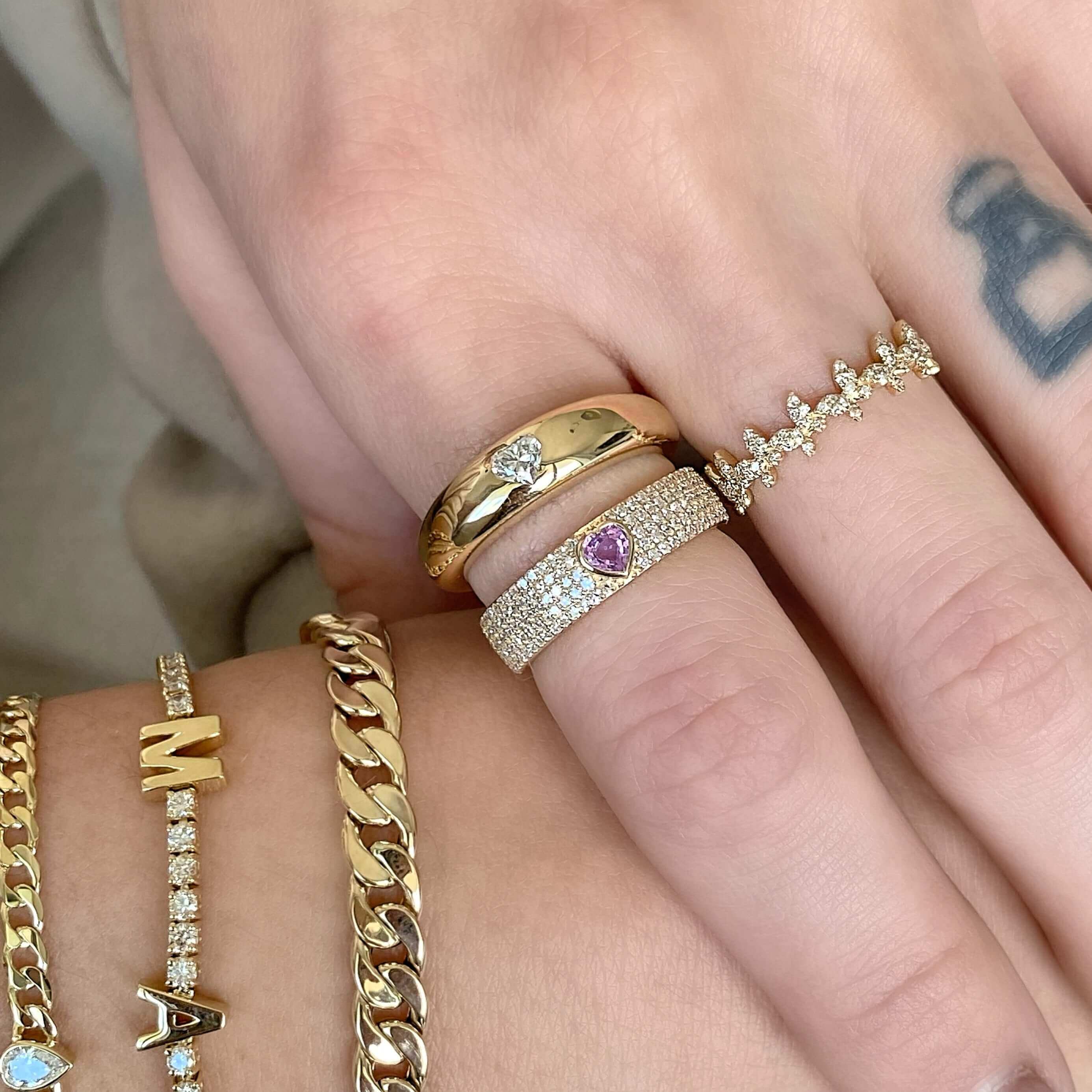 Elegant gold and diamond rings paired with stylish bracelets from our luxury jewelry collection.