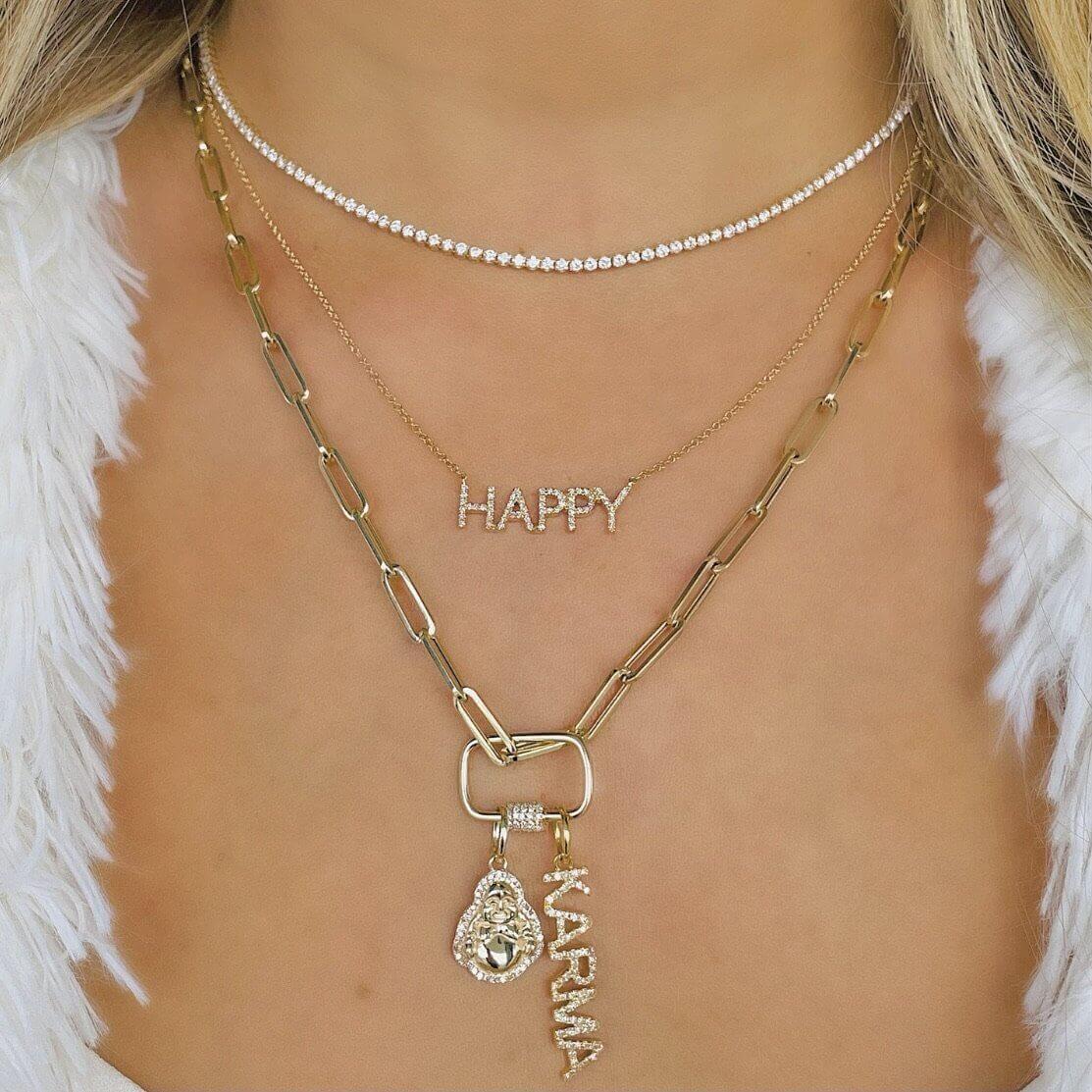 Layered gold and silver necklaces featuring "HAPPY" and "KARMA" charms from our jewelry collection.