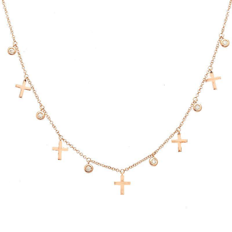Dainty gold necklace with cross and diamond pendants from our jewelry collection.