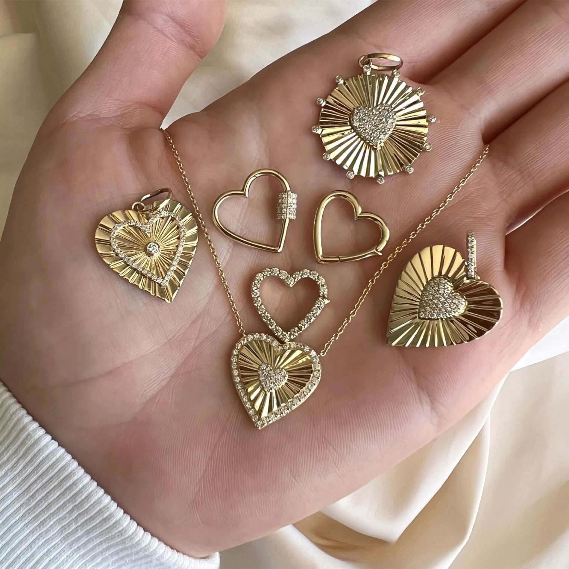 Hand holding luxurious gold heart-shaped jewelry with sparkling diamond accents from our premium jewelry collection