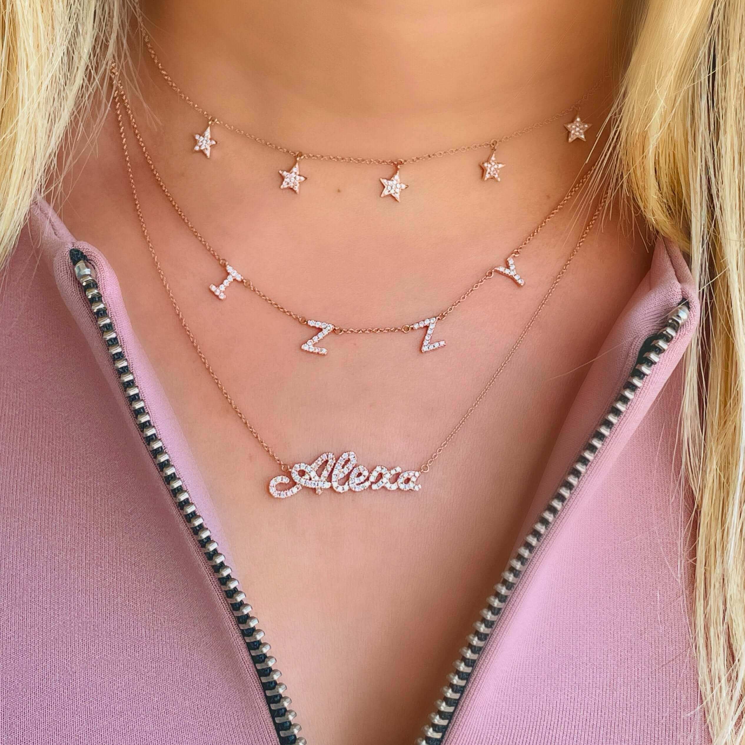 Layered star and name necklaces in gold from our elegant jewelry collection.