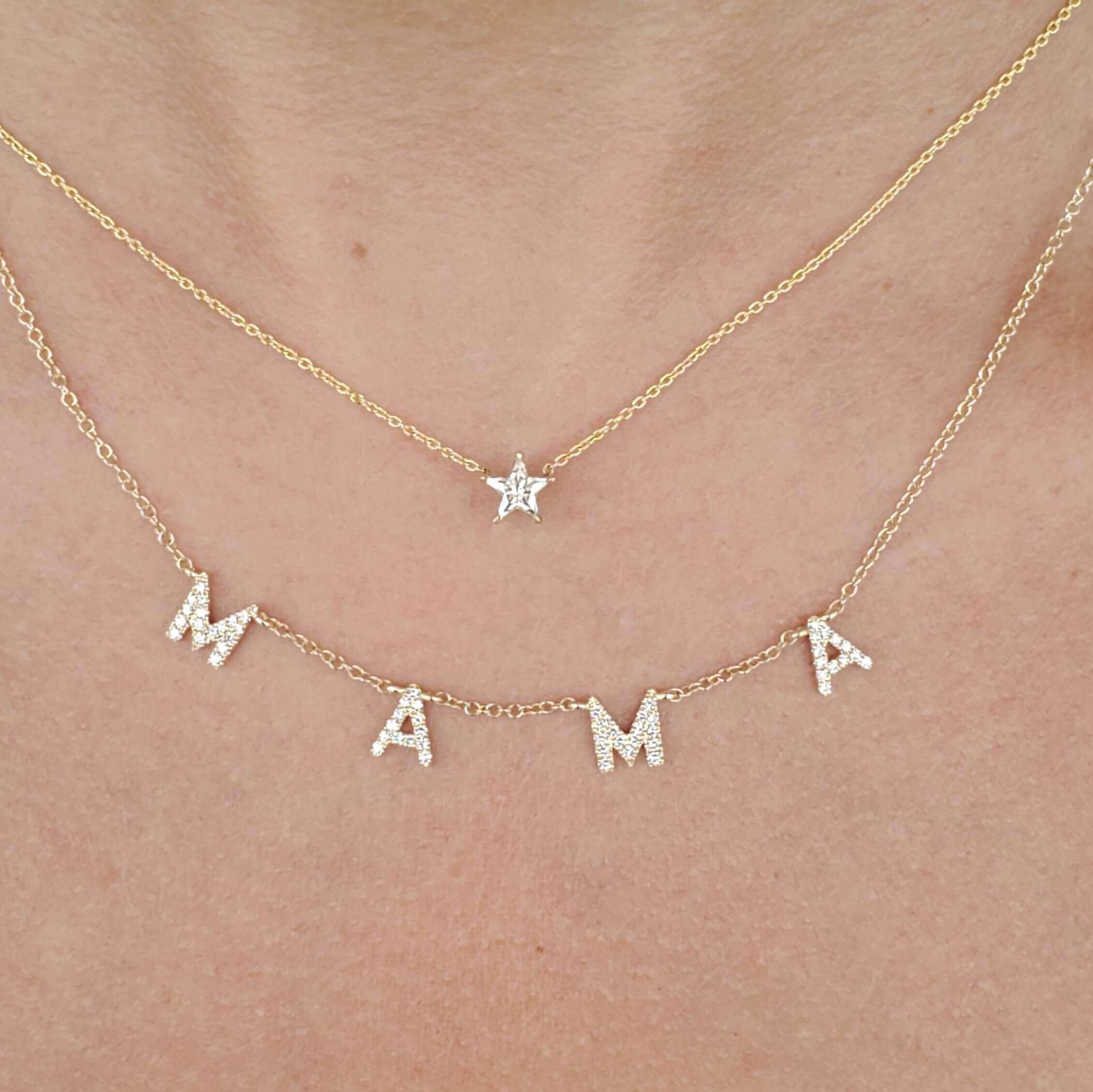 Gold "MAMA" necklace with diamond letters layered with star pendant.