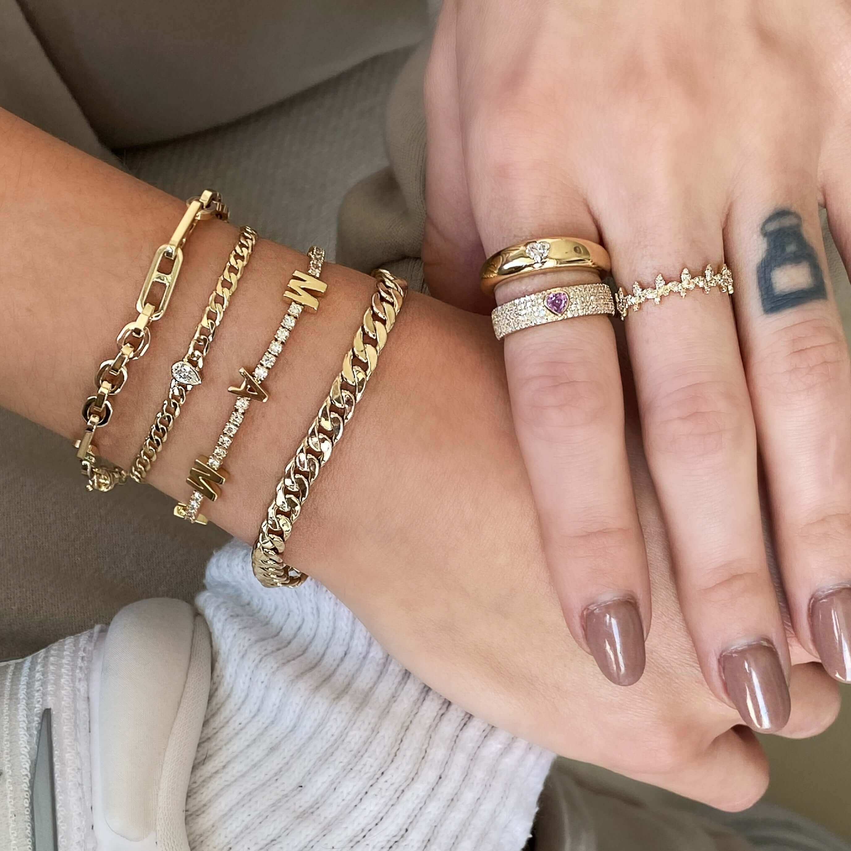 Gold jewelry set featuring chain bracelets and elegant rings from our exclusive collection.