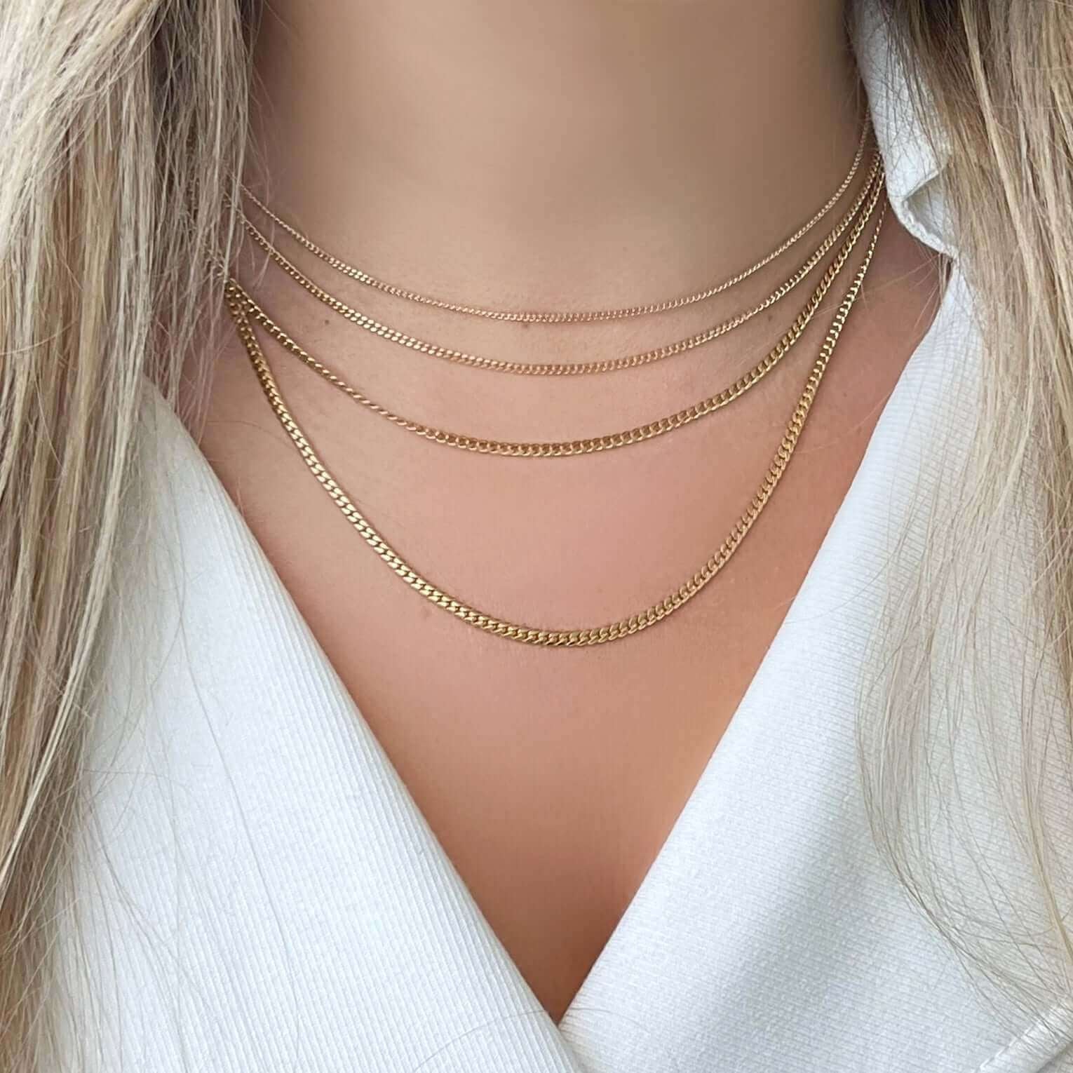 Miami Cuban Link Chain Gold Necklace displayed elegantly with layered chains.