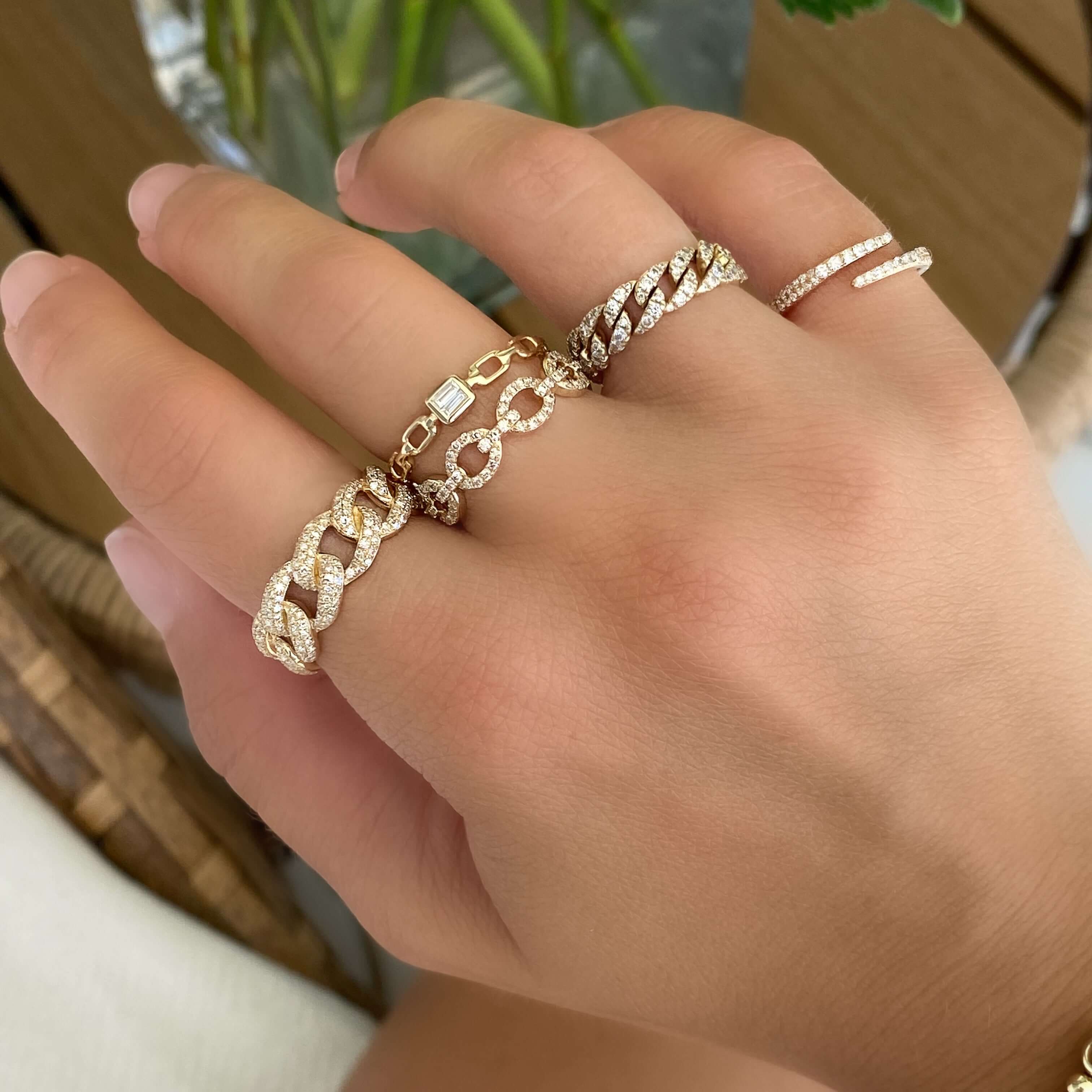 Elegant hand adorned with luxurious gold and diamond rings from our jewelry collection.